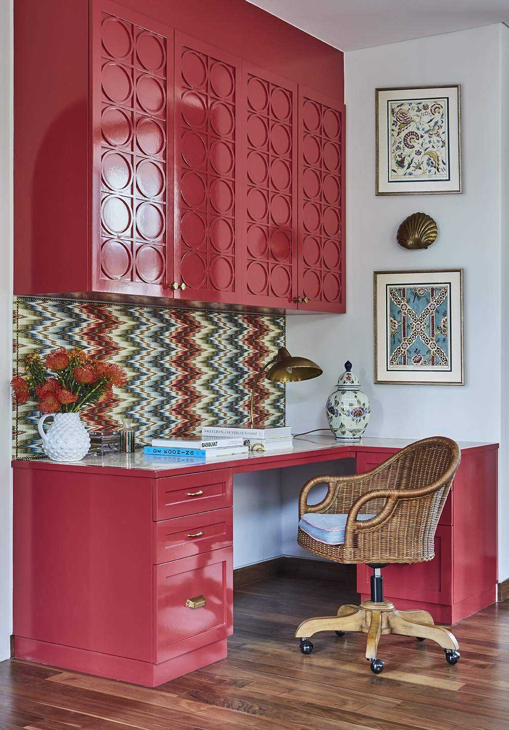 brightly colored home office with zigzag walls and cane chair