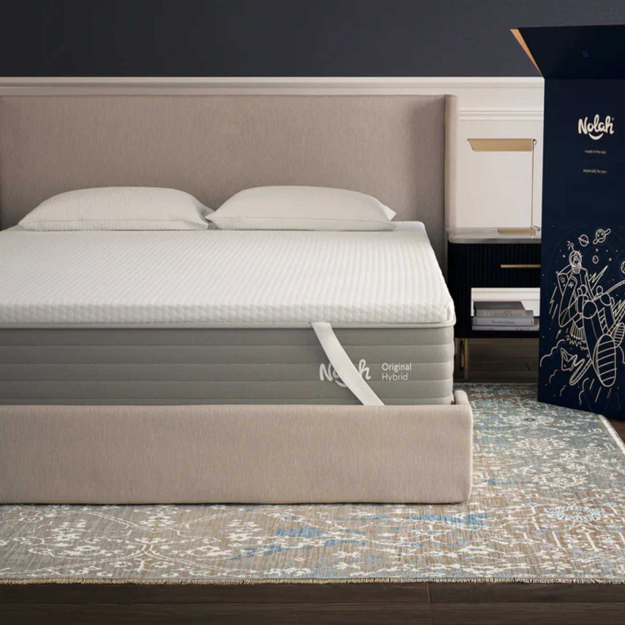 A white Nolah AirFoam&reg; Luxe Mattress Topper on a beige bed with beige headboard, on a Persian-style rug.