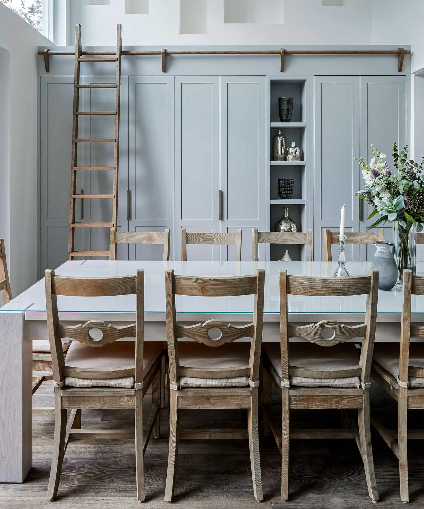 family kitchen with tall hidden storage and wood table and chairs