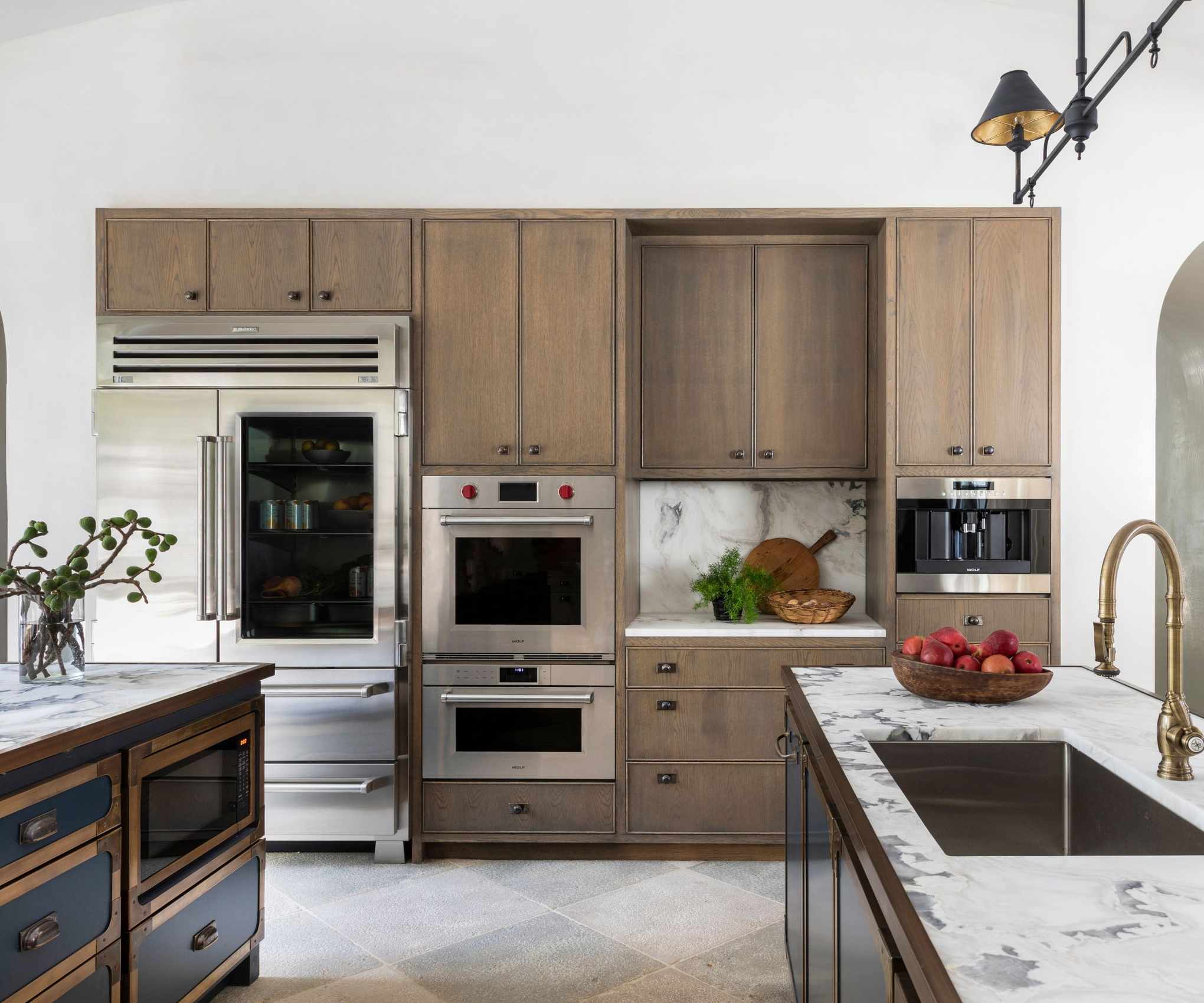 Country style kitchen with white countertops decorated with wooden cutting boards