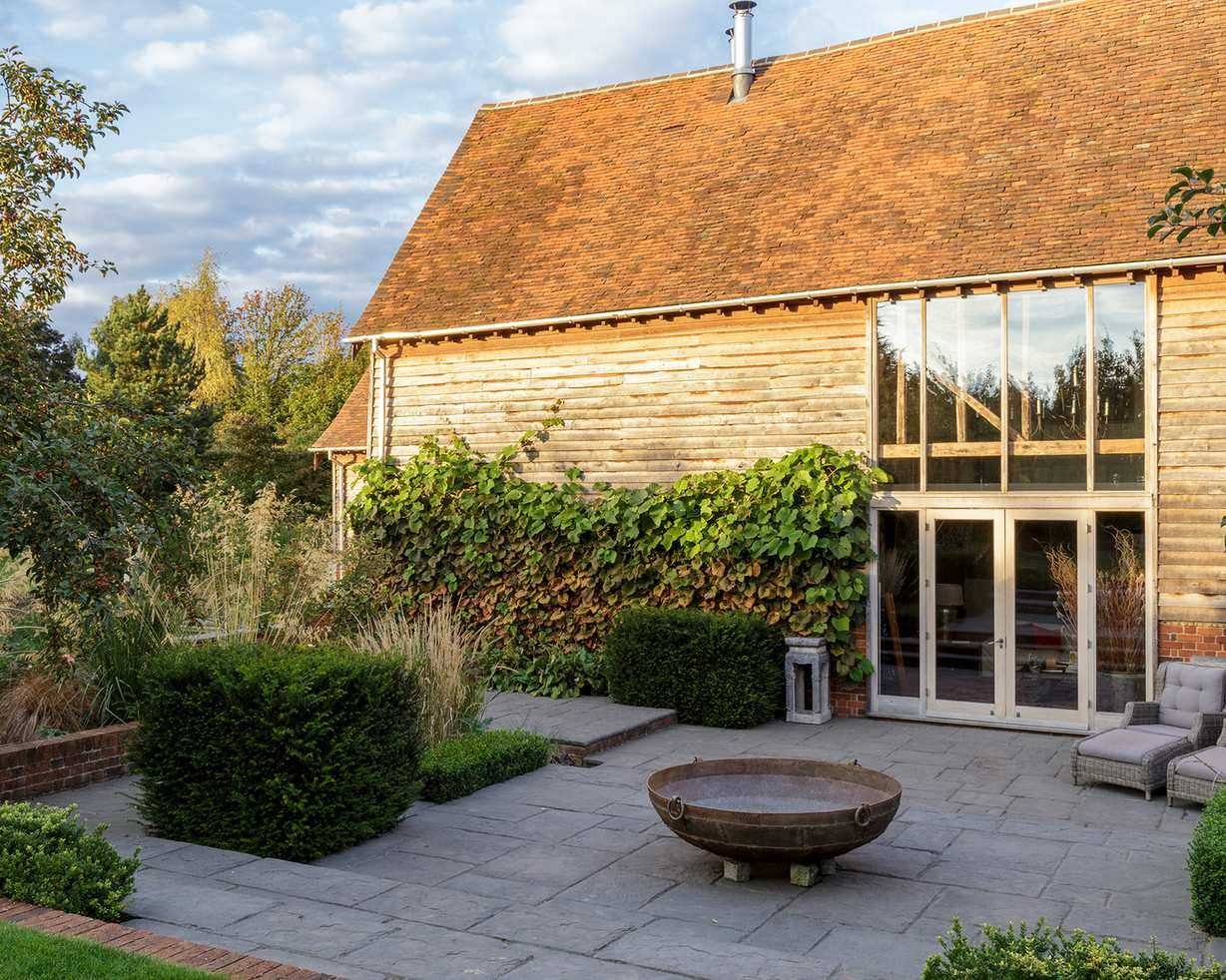 An example of how to plan a small garden, with a firepit and box hedges in a patio space.