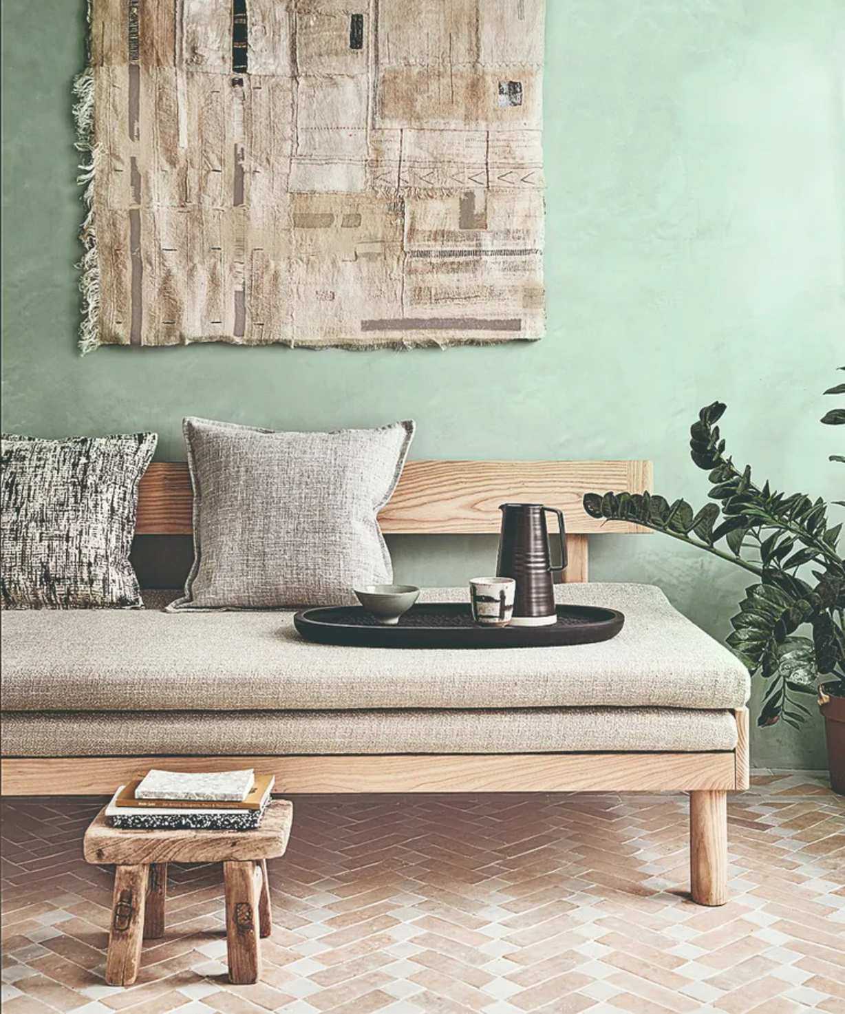 Green wall, notepads, tea tray, grey cushions
