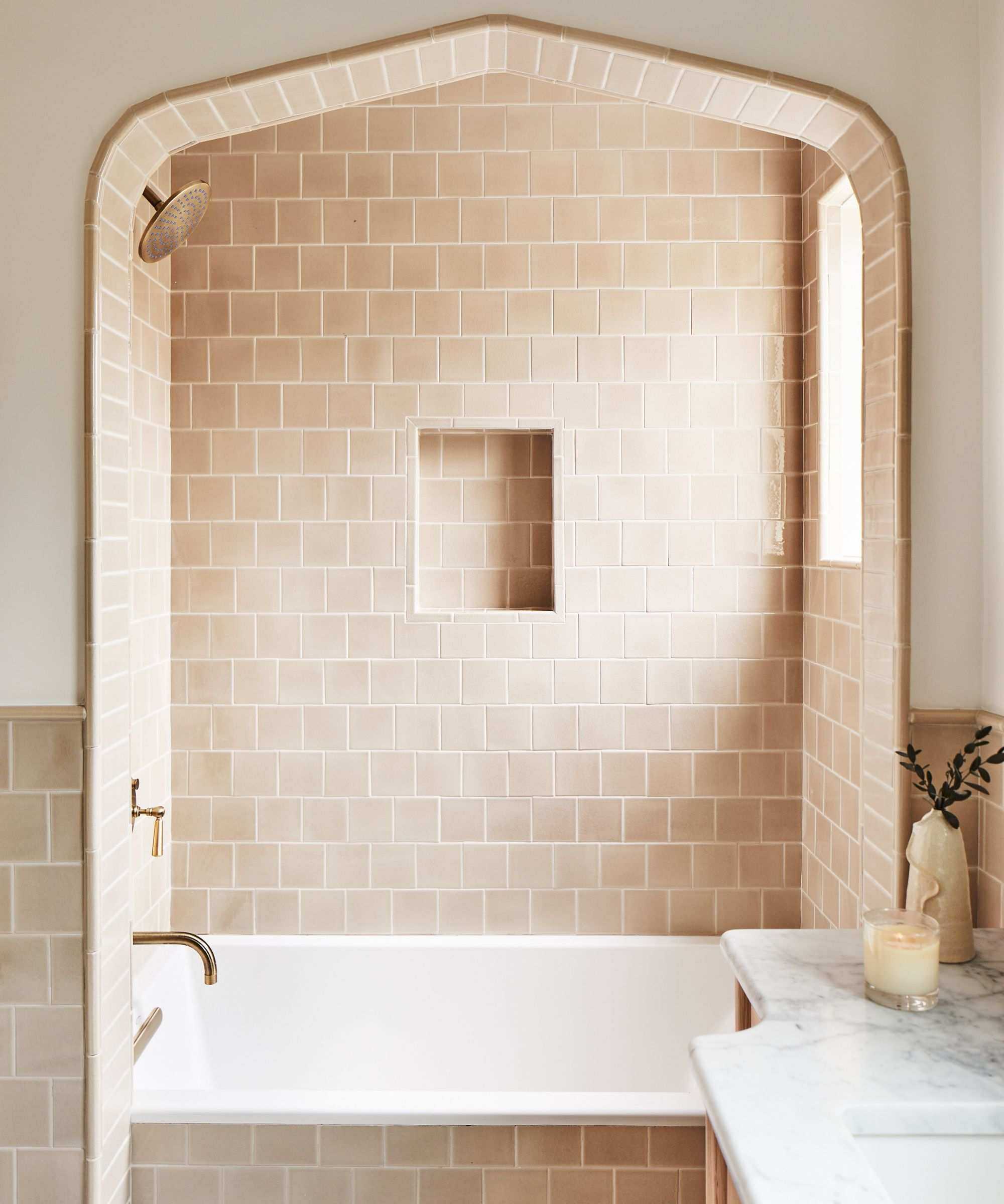 Warn neutral bathroom with warm white walls and beige square tiles