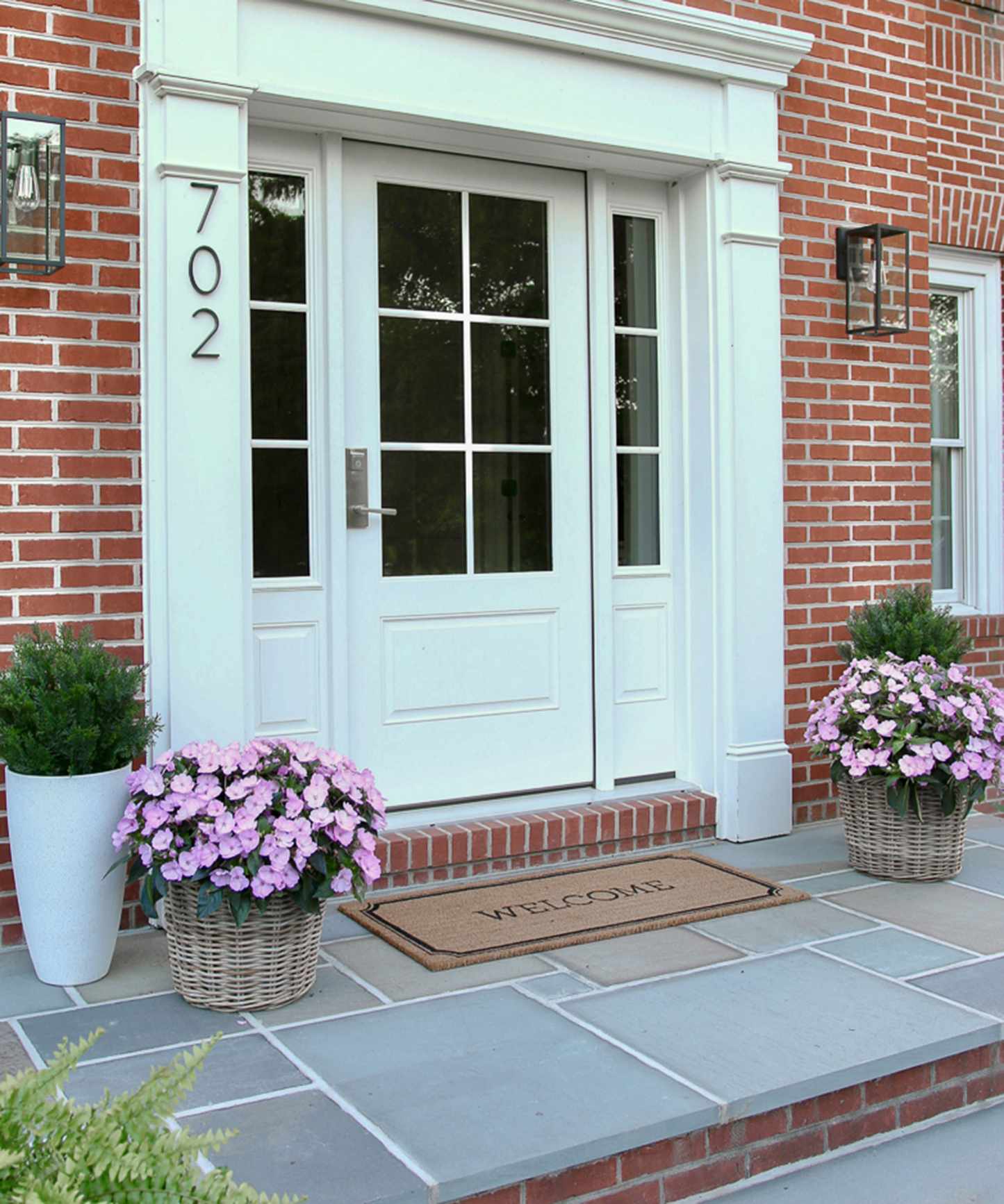 front door with busy lizzies planted up in container