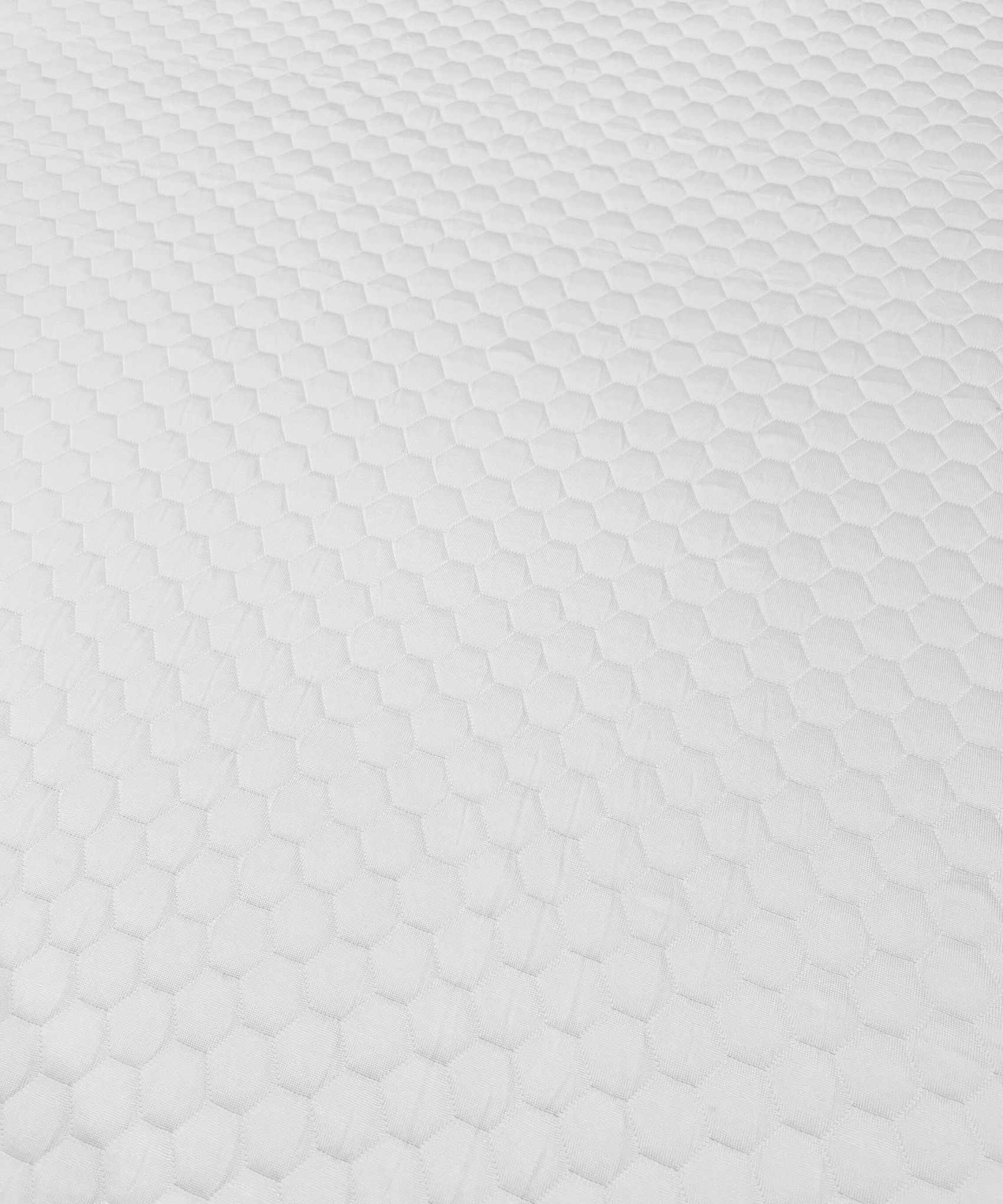 A close-up of a white Nolah AirFoam® Luxe Mattress Topper