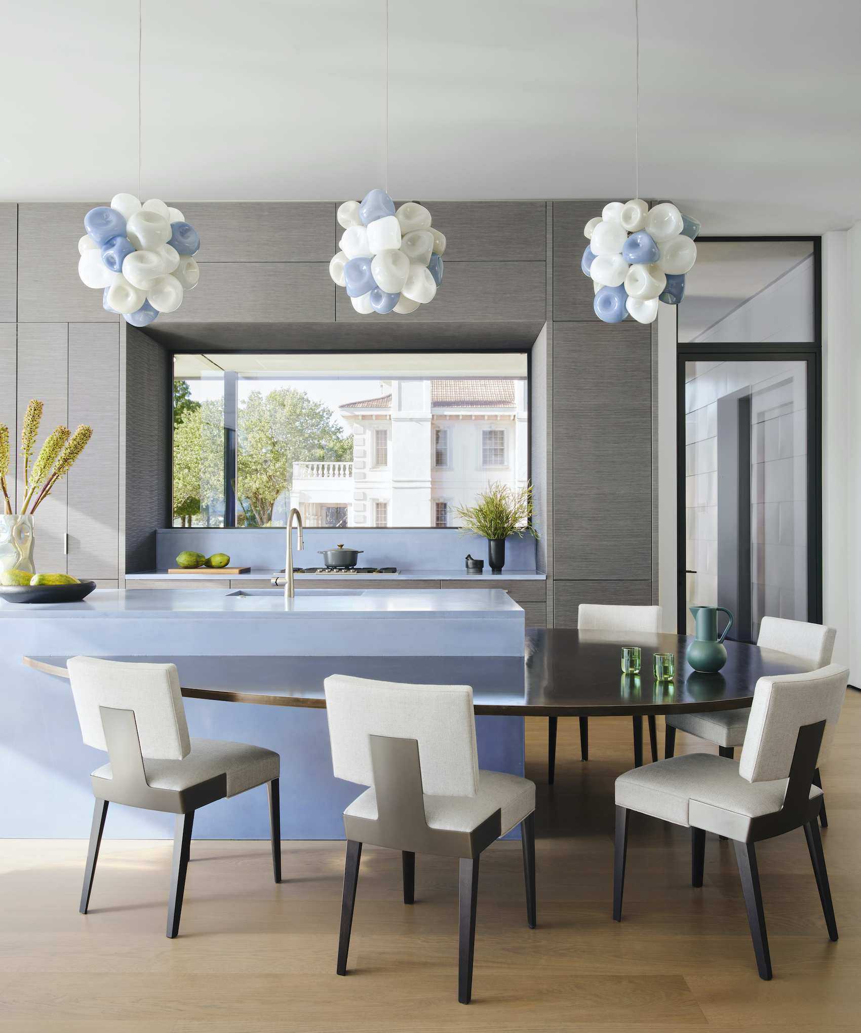 blue kitchen island with drop level table and dining chairs