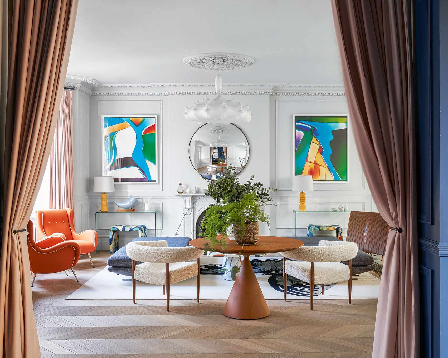Mid-century modern style living room with modern art, white walls and curved chairs