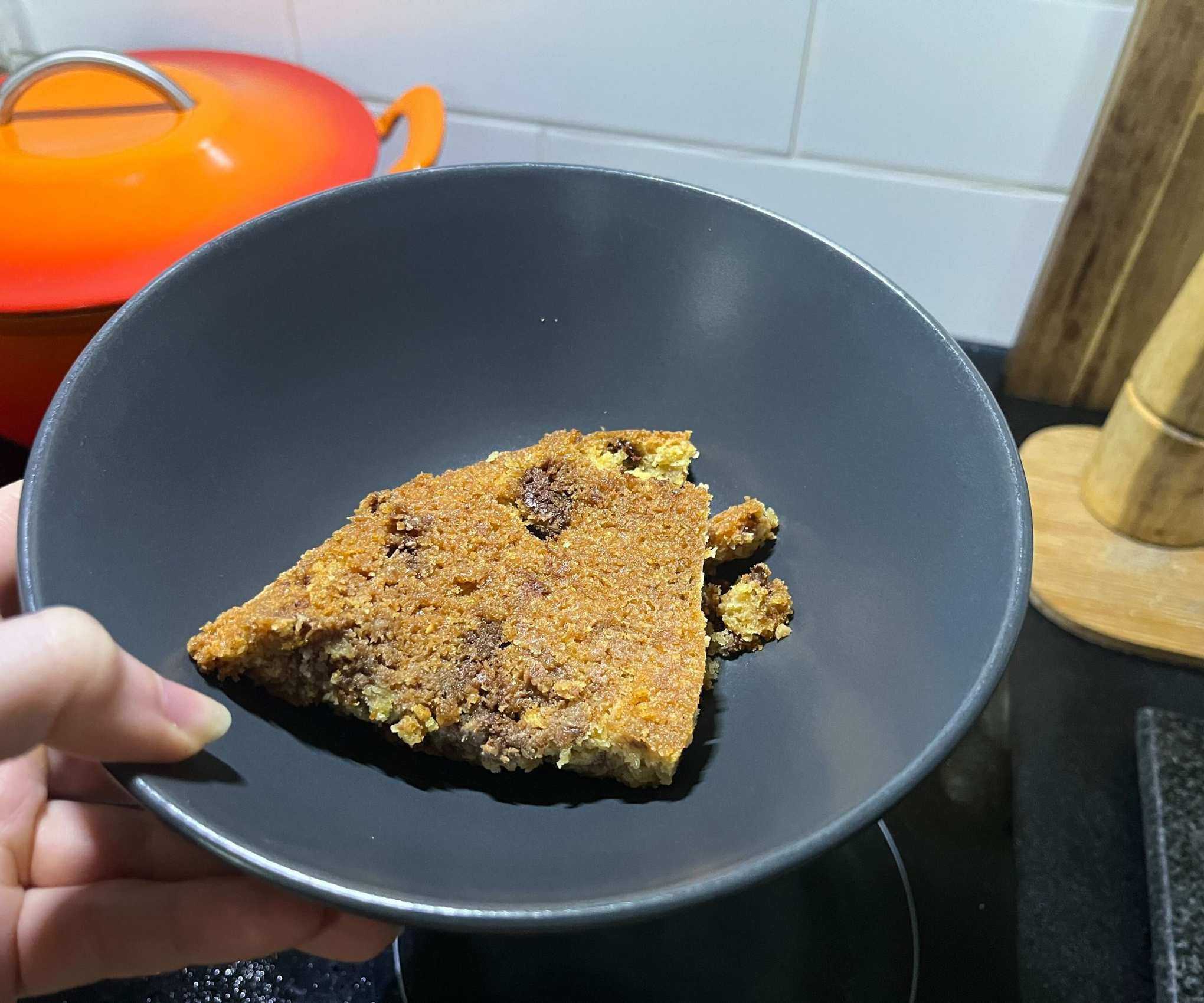 The crisp base of a skillet cookie in a grey bowl
