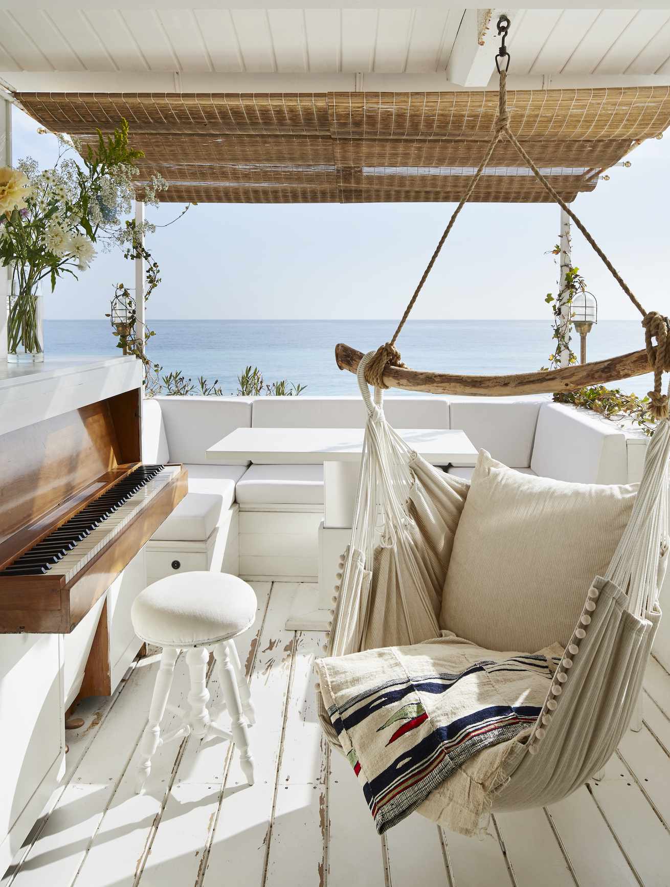 desk with white wooden boards piano and hanging chair