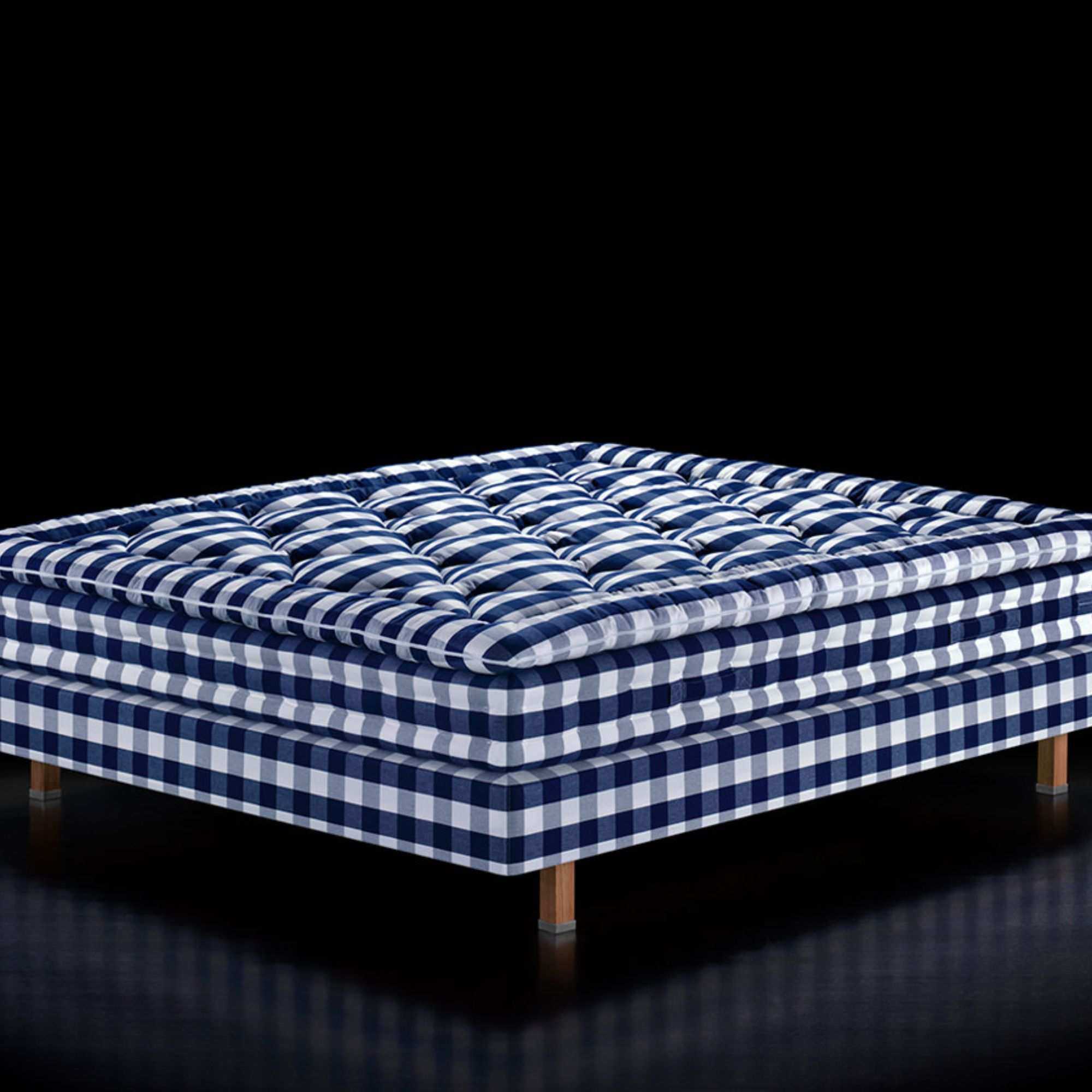 H&auml;stens Maranga Mattress against a black background.