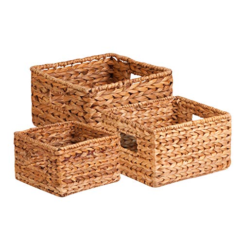 A set of three woven wicker baskets, reducing in size. Cut out handles.