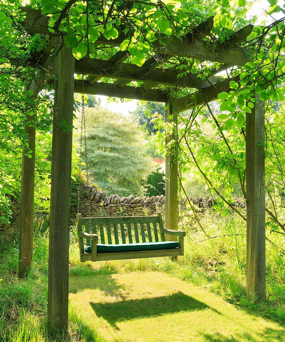 a pergola idea with a swing seat in a design by Ali Paterson Garden Design
