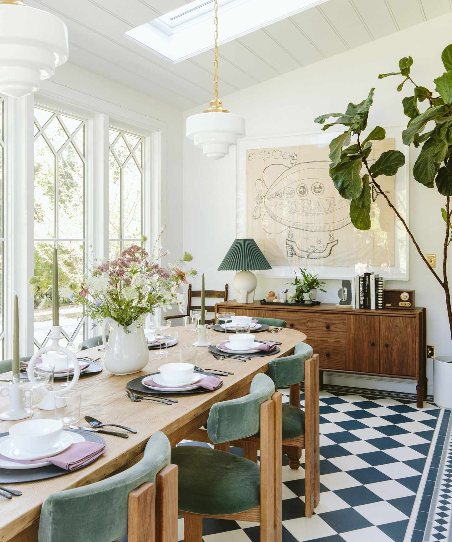 sunroom dining room with checkerboard flooring and large table