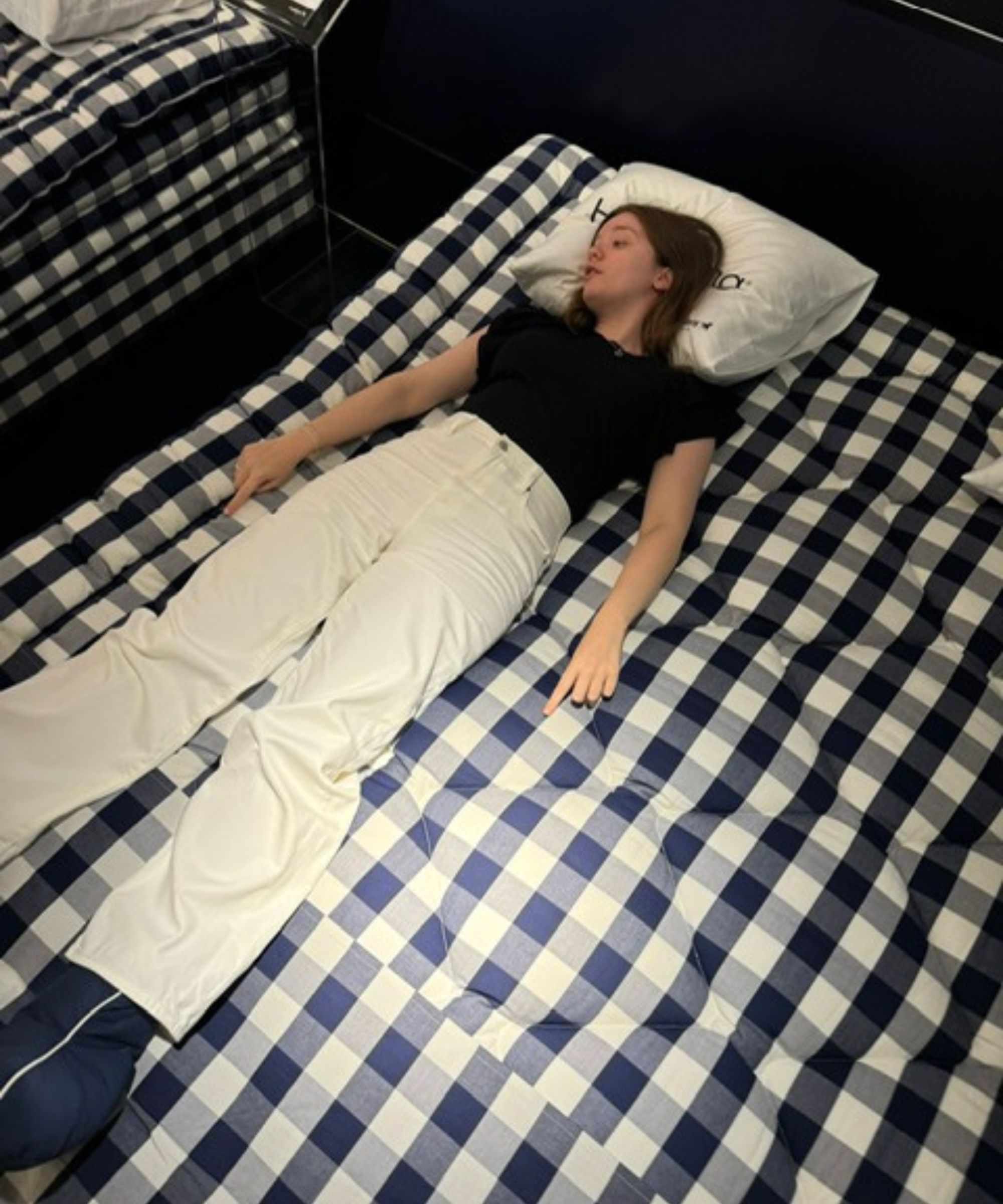 Emilia lying on the H&auml;stens Herlewing sleep system.