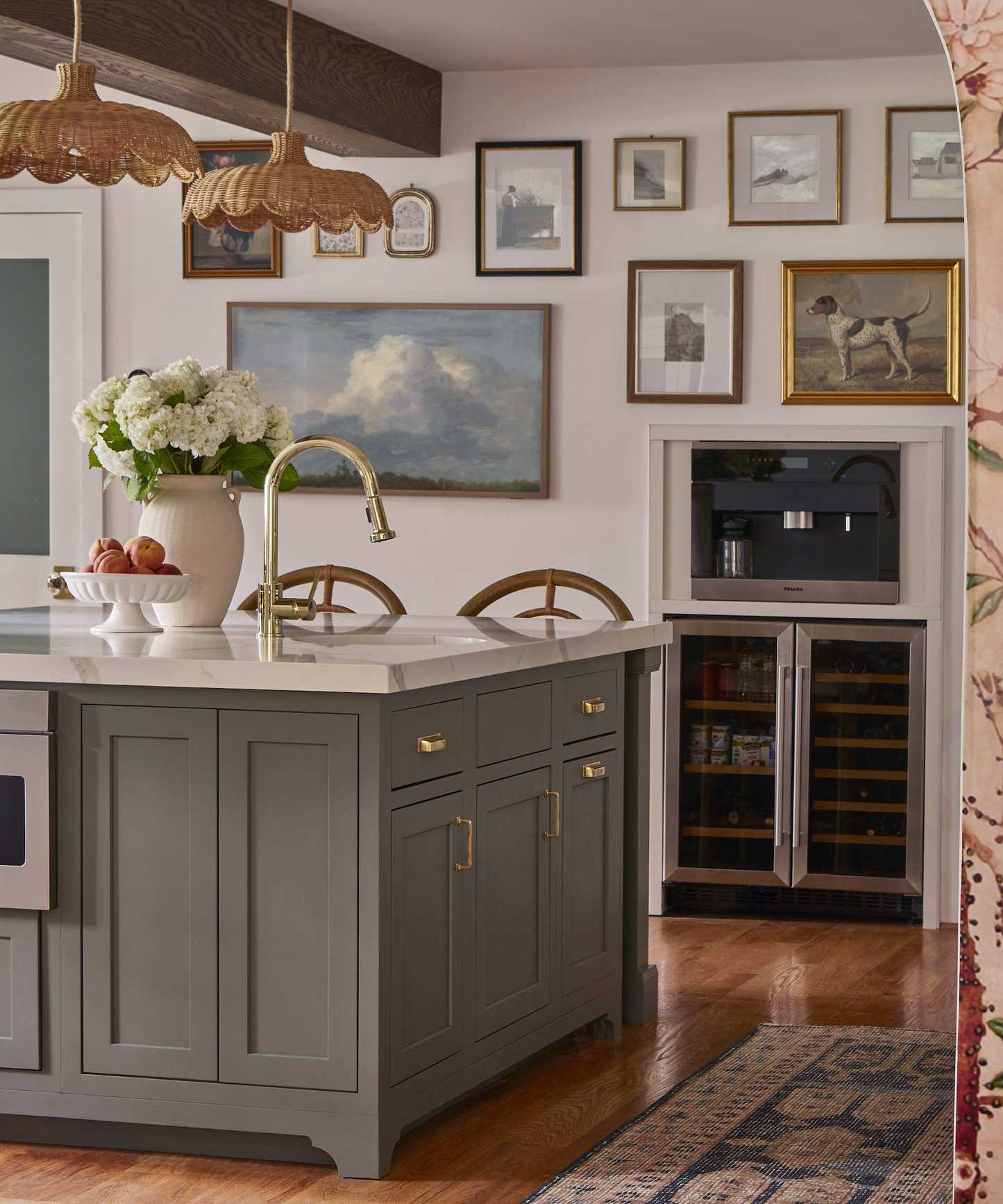 kitchen with island with tap and sink and wine fridge in the background