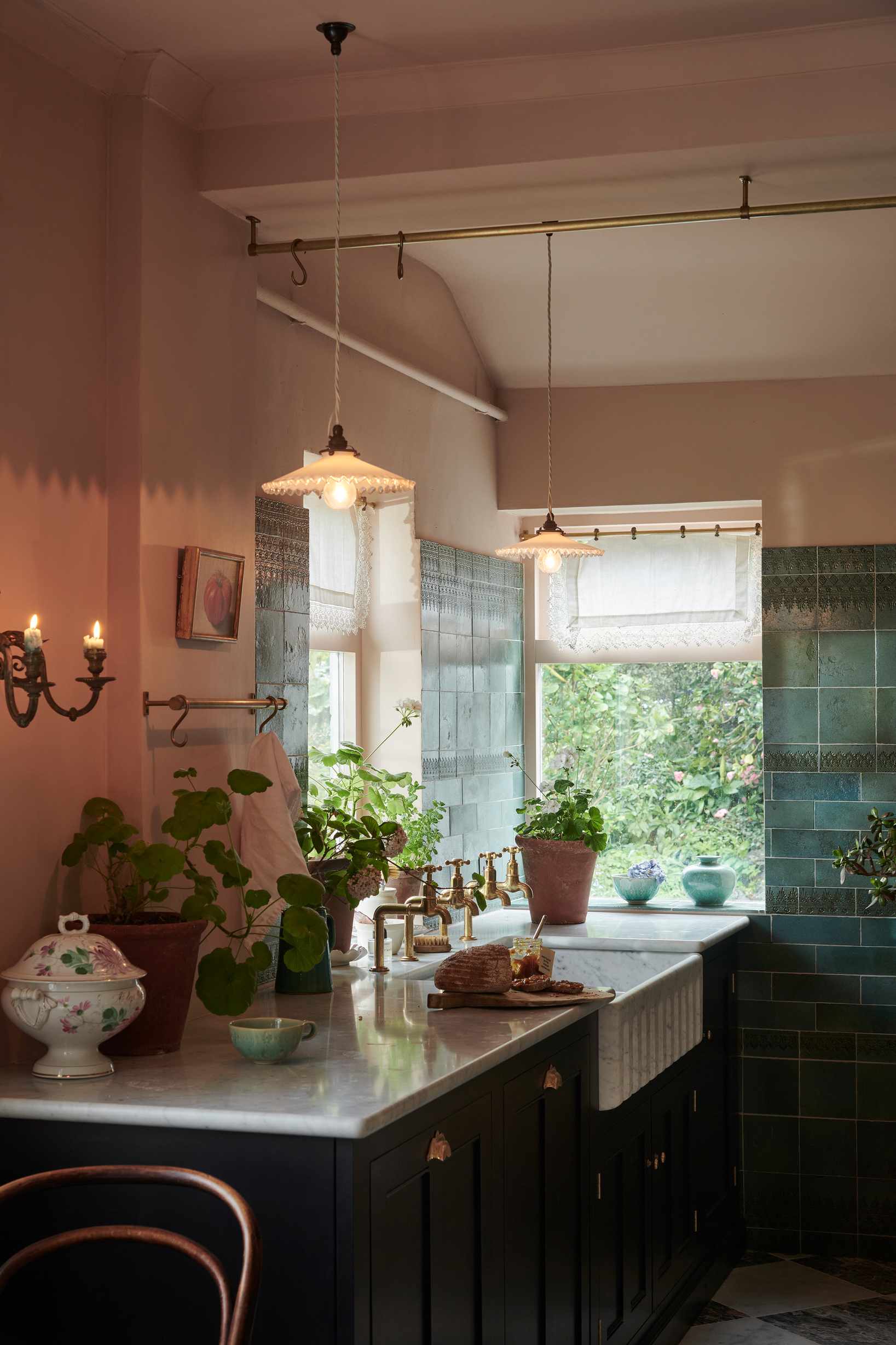 Green tiled wall, black base cabinets