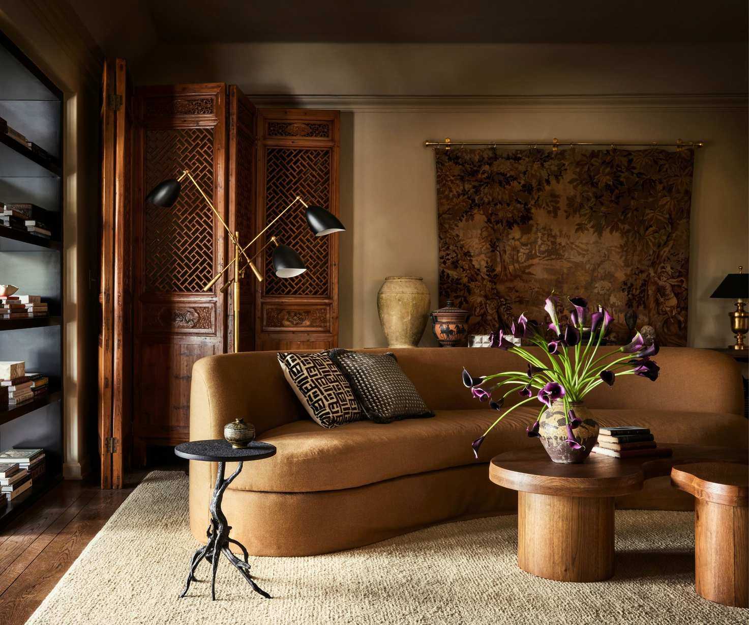 Living room design by Plaster &amp; Patina painted in Riverbed by Dunn Edwards featuring a curved sofa in tan fabric