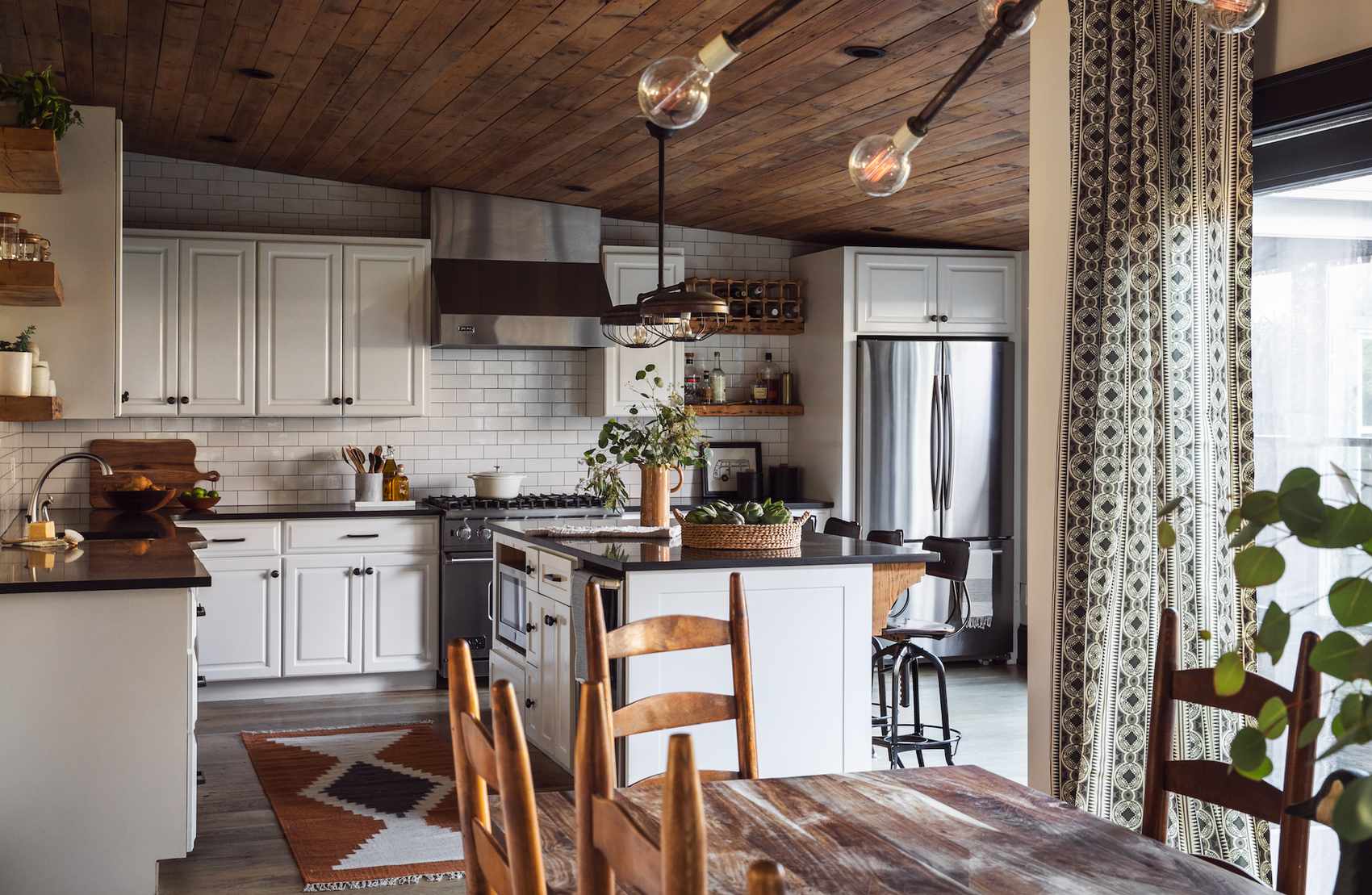 rustic kitchen with wooden ceiling and white metro tiles