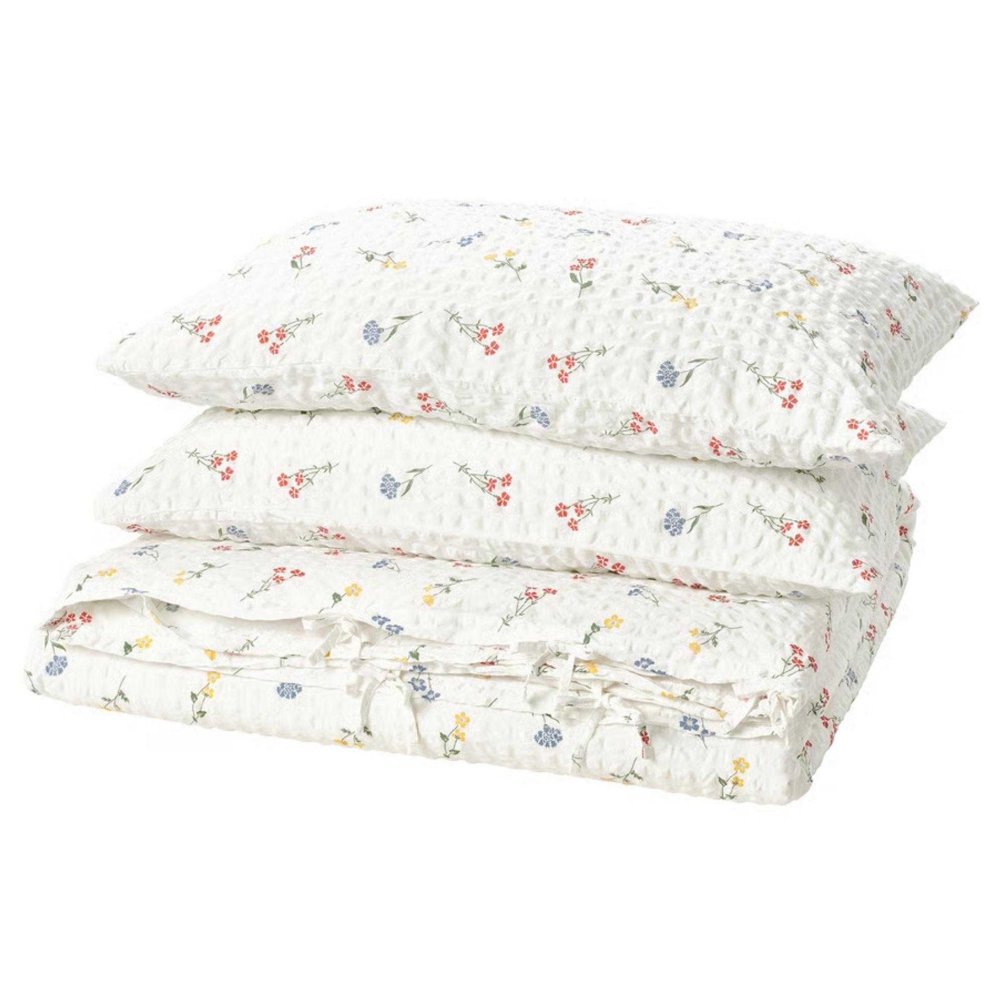 IKEA floral white PILDV&Auml;RGMAL Duvet cover and pillowcases folded in a pile