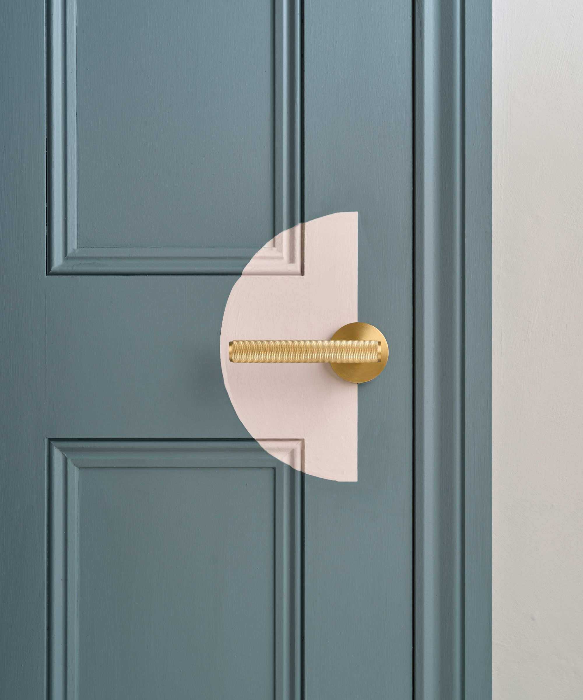 A grey internal door with a painted motif of a pink semi circle by the door knob