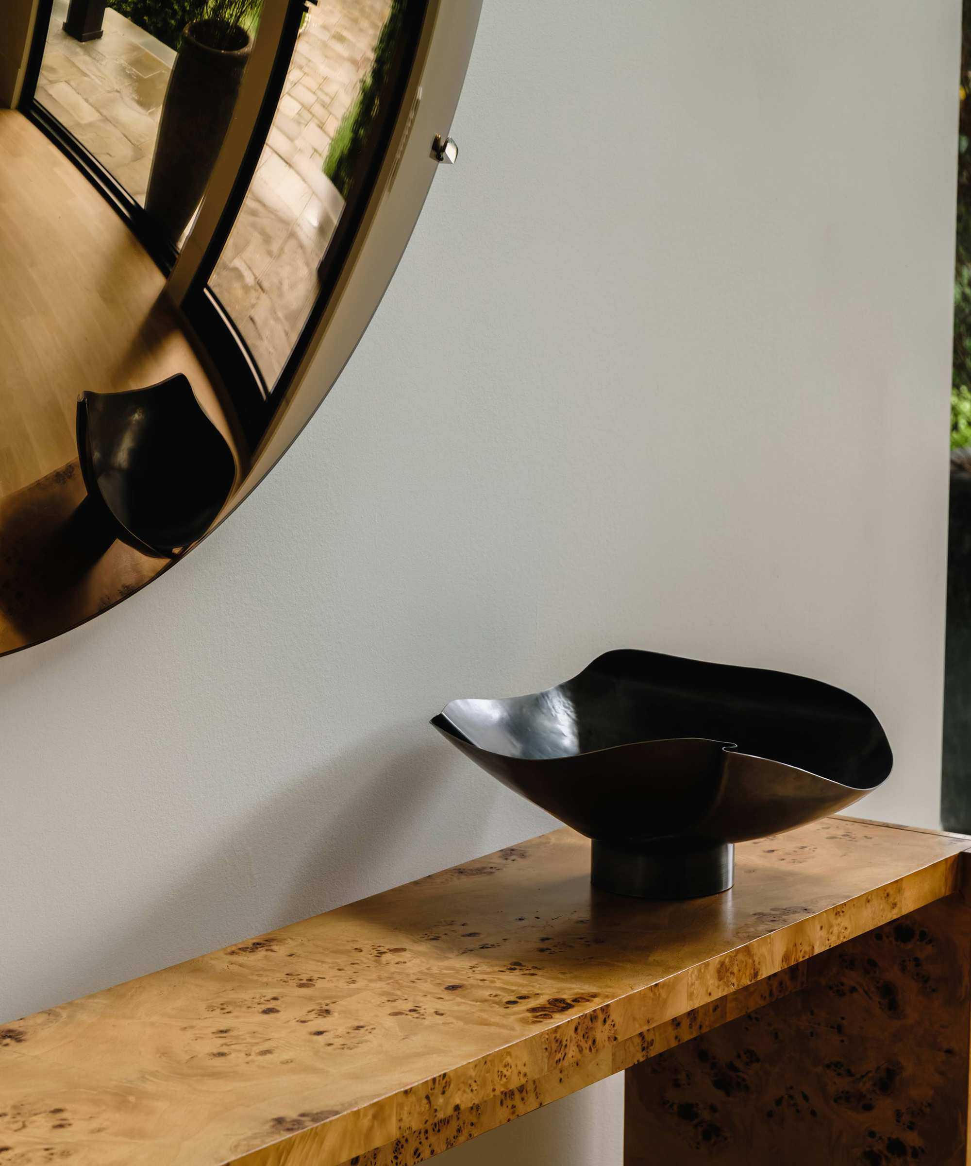 entryway console with sculptural bowl on it