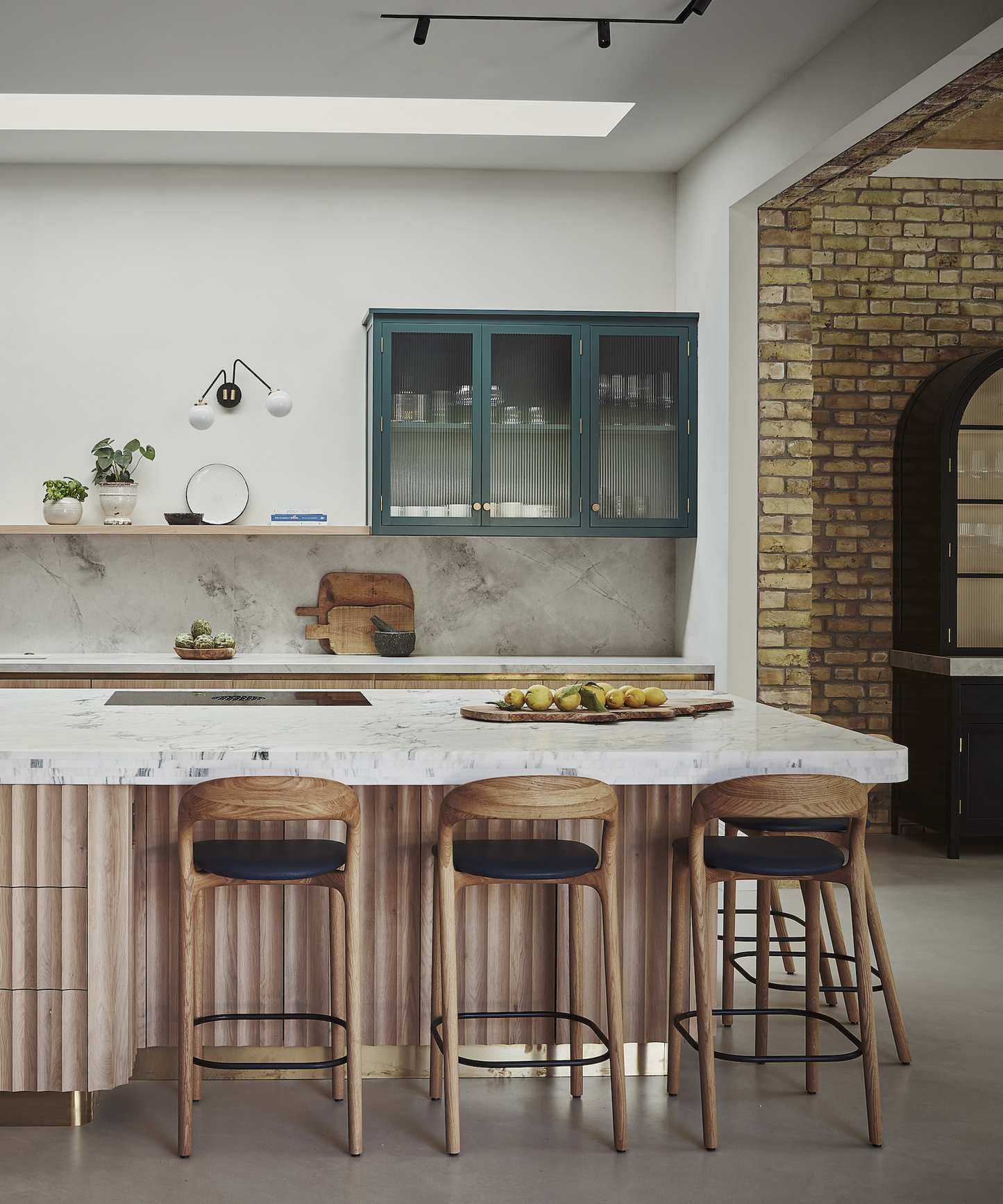 wood kitchen island with ribbed sides and bar stools