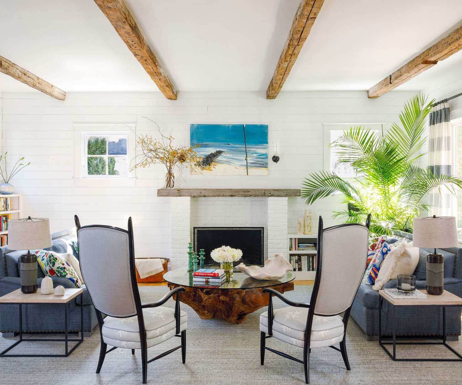 living room with white walls and ceilings with white armchairs and fireplace
