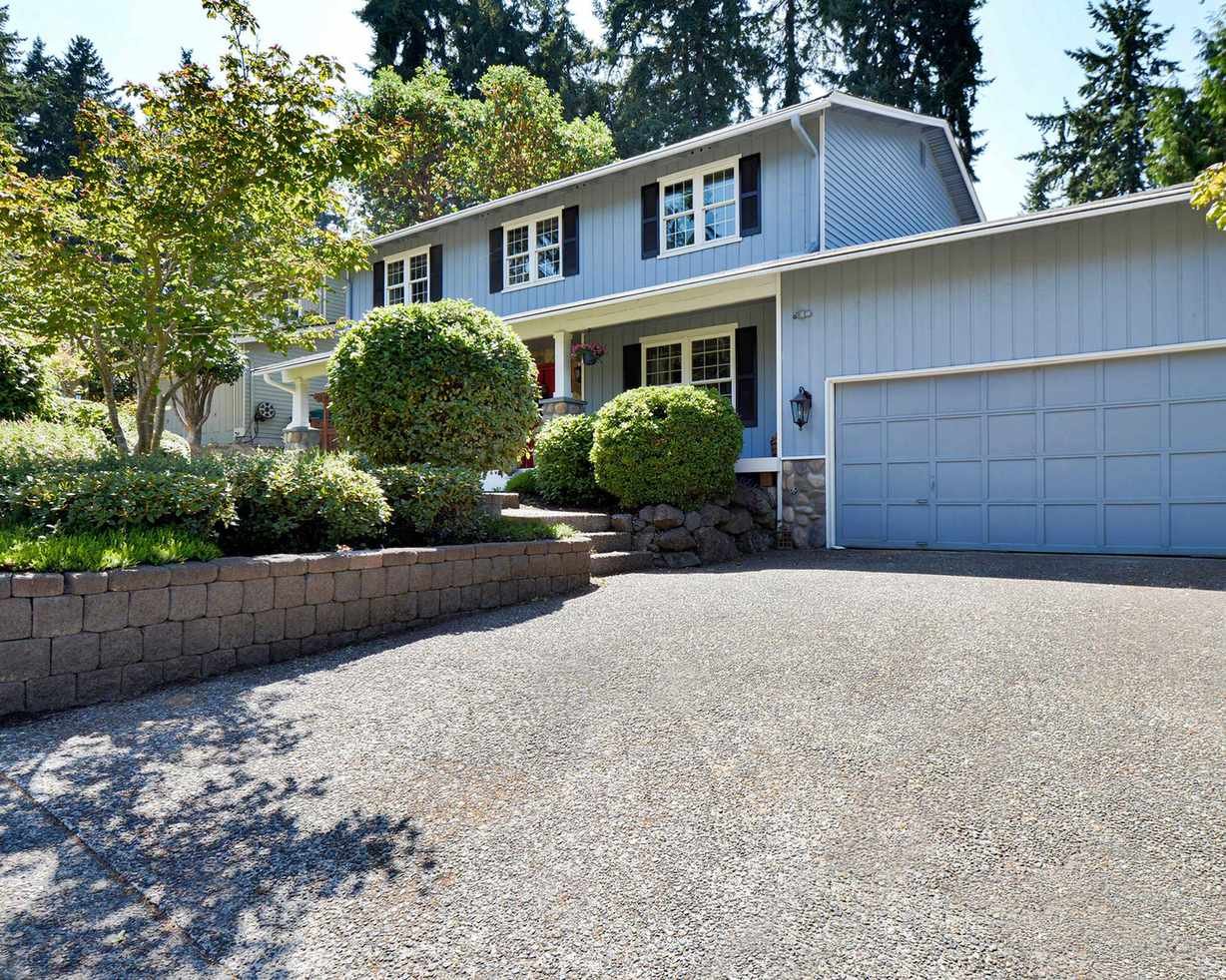 concrete driveway with blue garage door