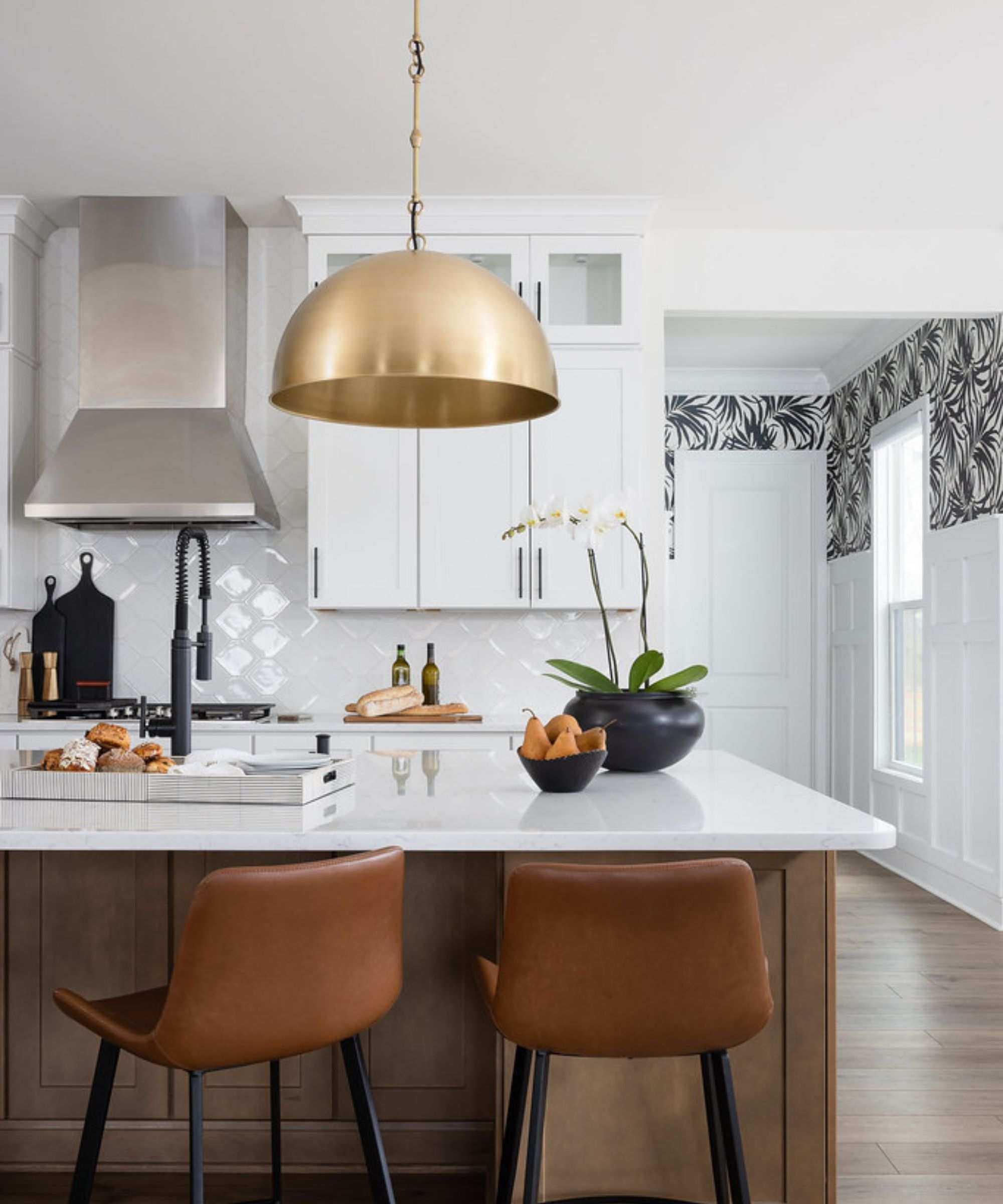 Large gold kitchen pendant lighting above a kitchen island