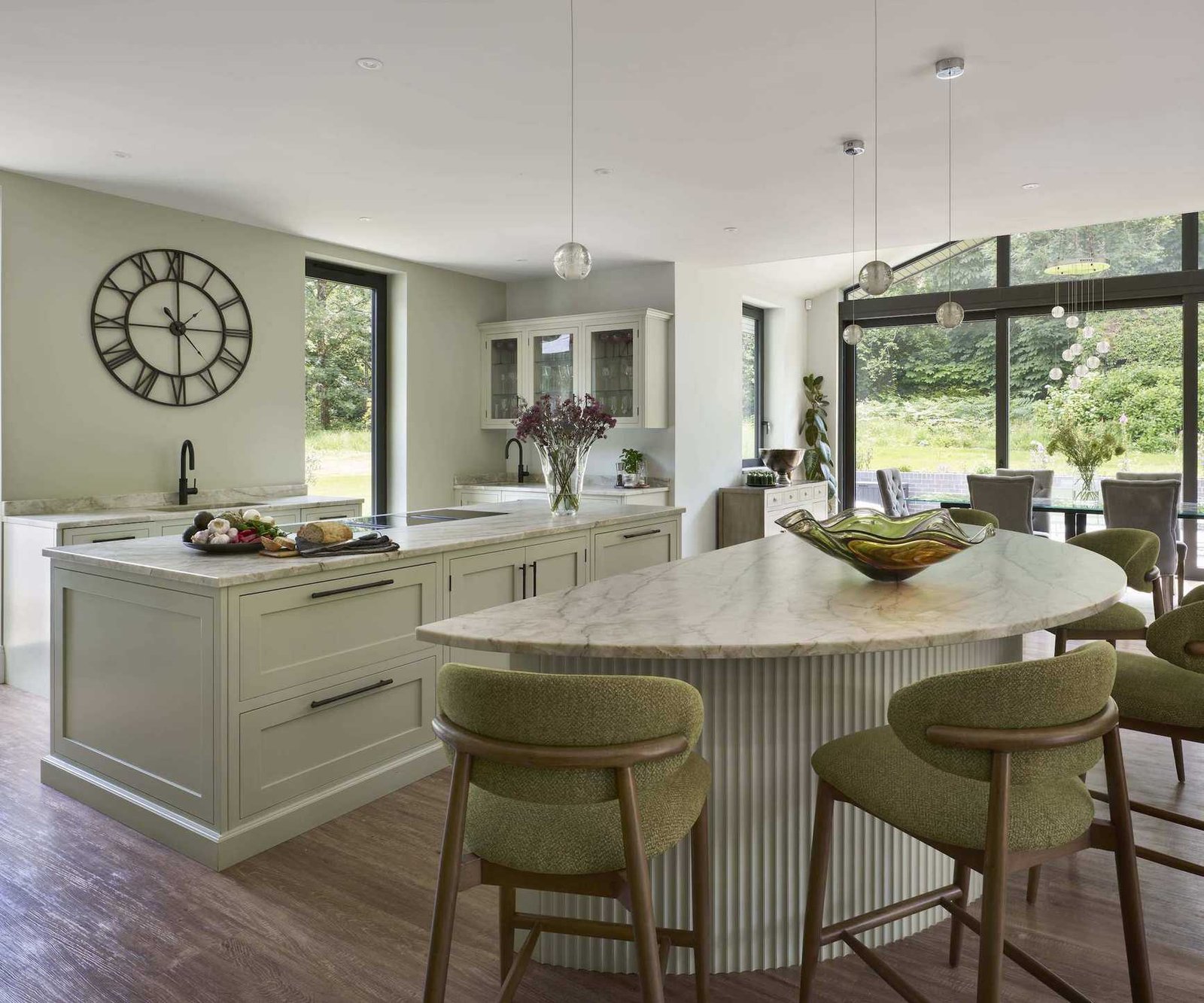 kitchen with two islands and green stools