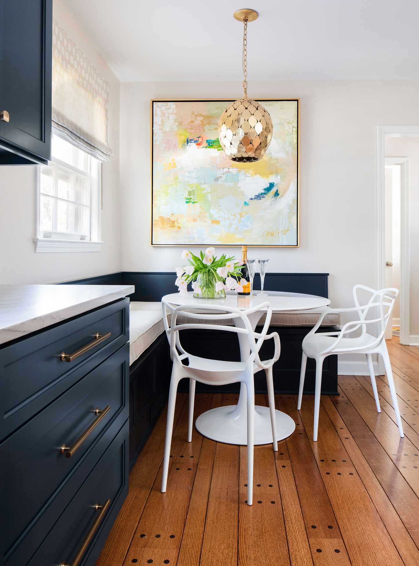 Galley kitchen with blue cabinets and wood flooring