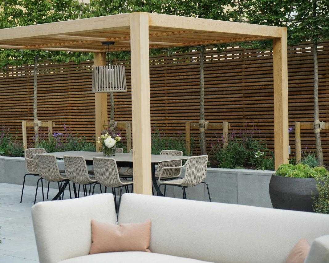 pergola idea for creating a dining area in a modern garden design by Farlam &amp; Chandler