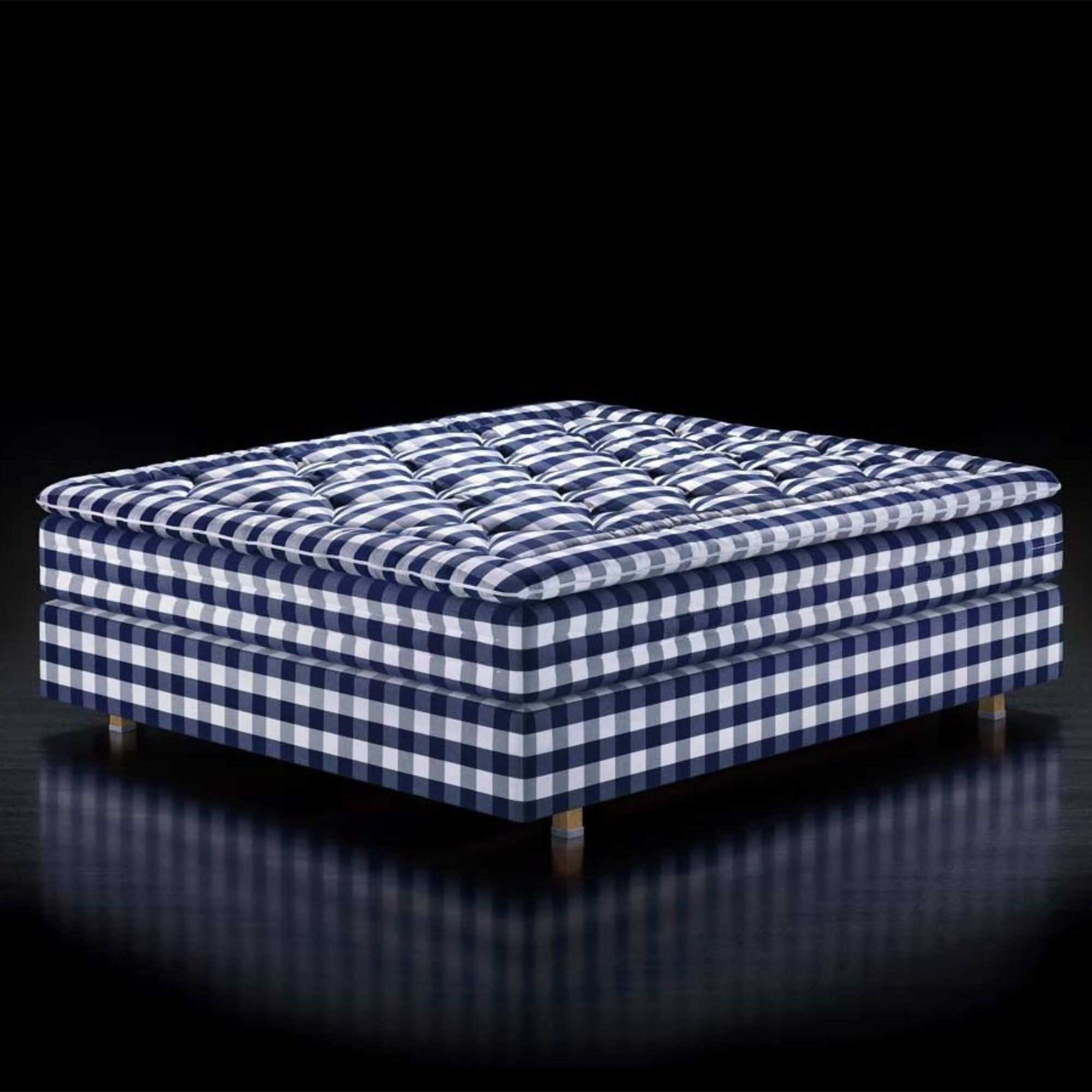 H&auml;stens Herlewing Mattress against a black background.