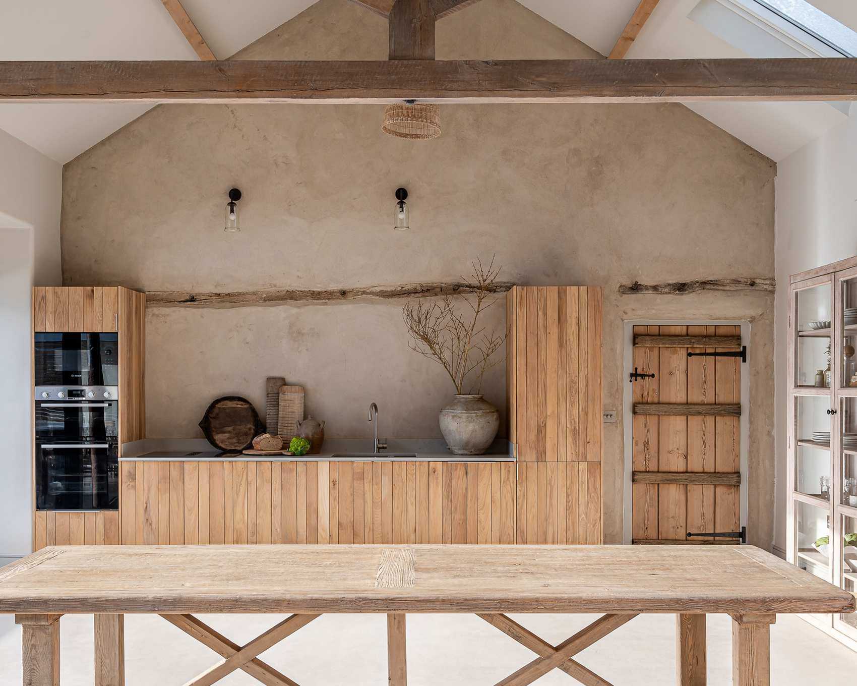 Galley kitchen with wood cabinets and plaster wall