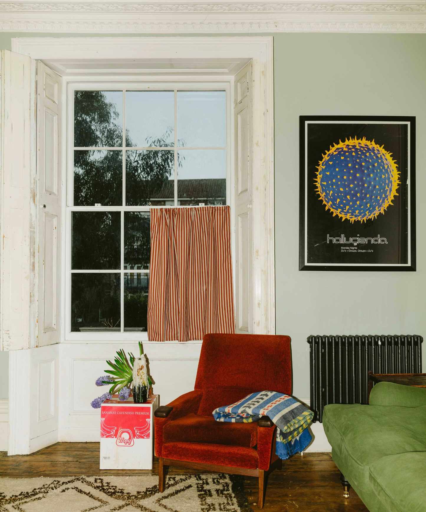 colorful living room with a striped red cafe curtain