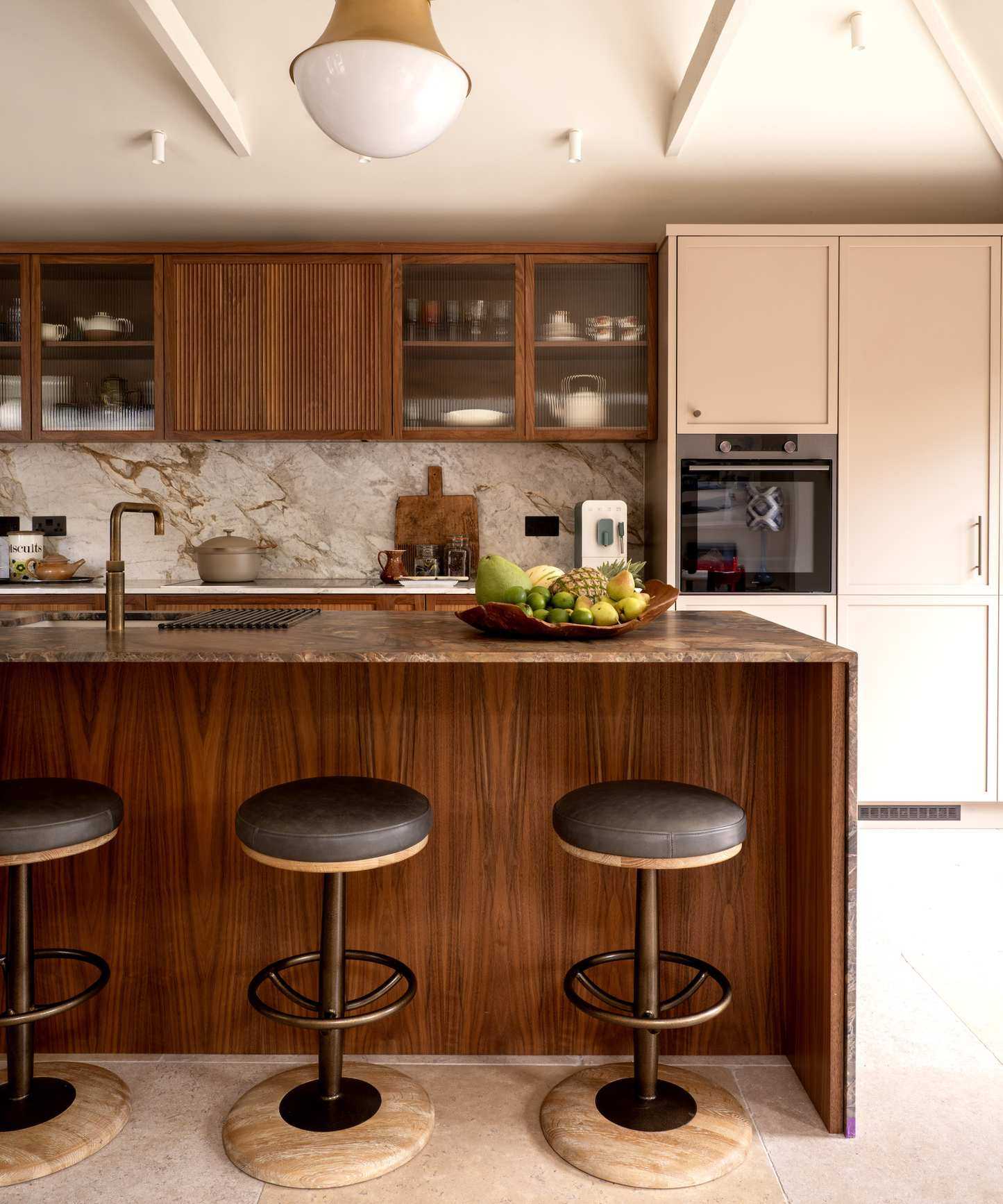 walnut kitchen island with three bar stools