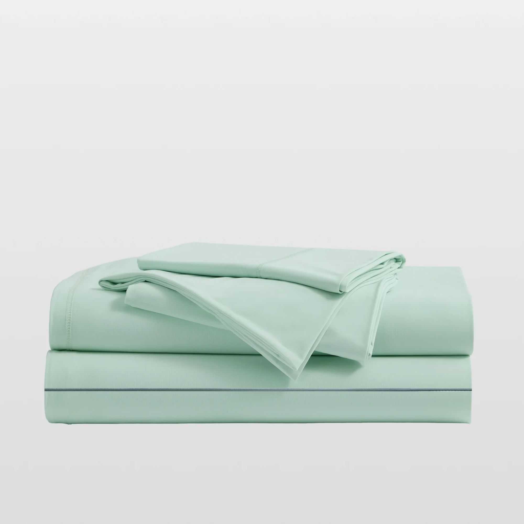 Mint green Breescape cooling sheets folded up in a pile