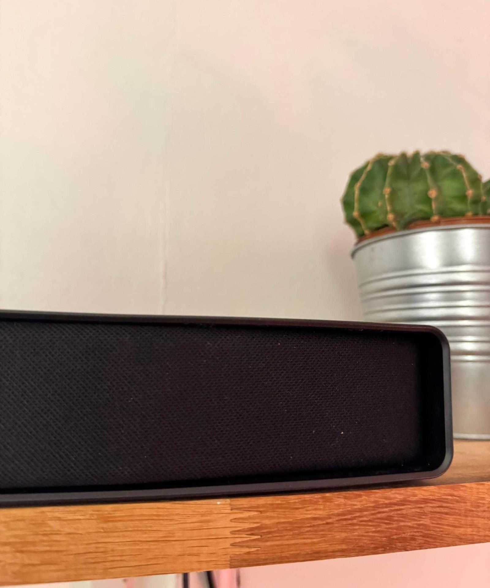 Hisense AX5140Q soundbar on wooden shelf, pictured in front of potted cactus.