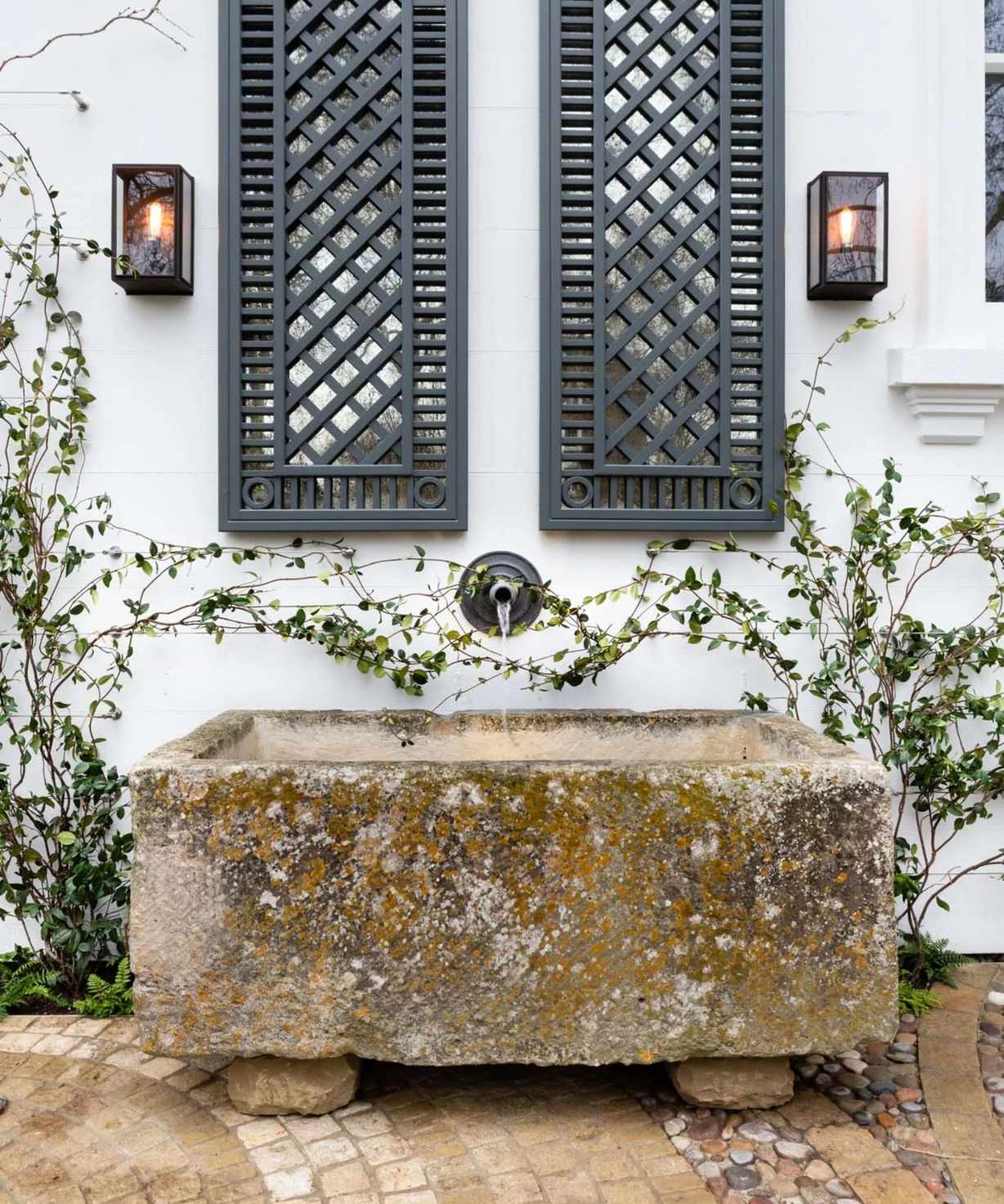 vintage lantern wall sconces with a vintage water trough by Butter Wakefield
