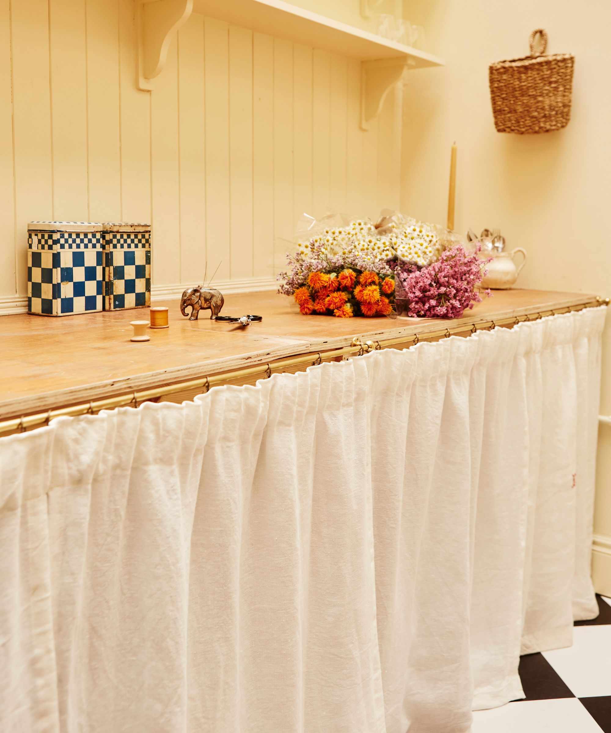 pale yellow pantry with a cafe curtain and shelving