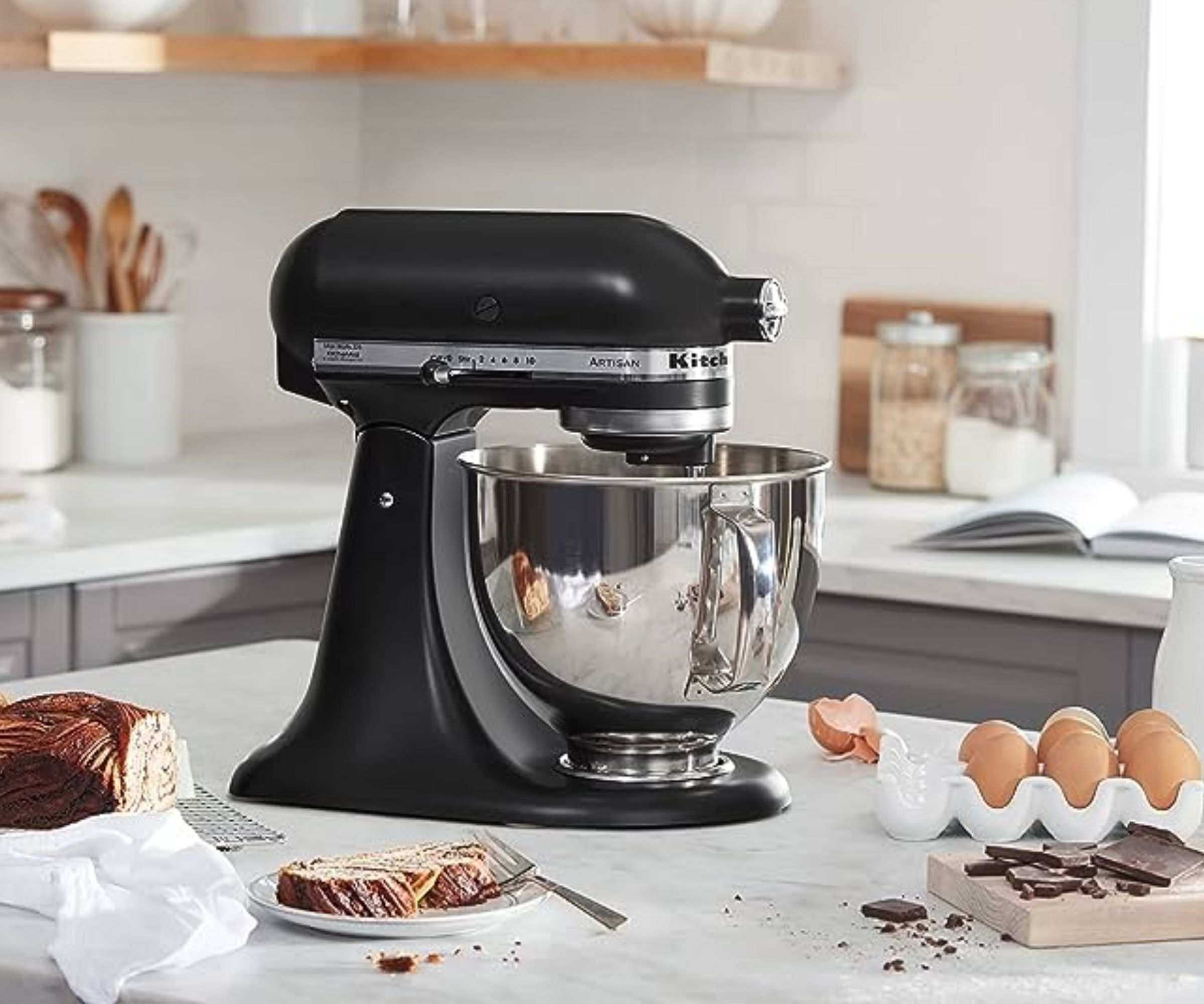 KitchenAid Artisan Stand Mixer on a countertop with baking ingredients around it