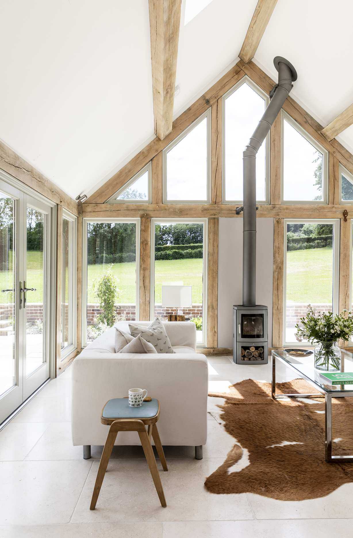 cozy sunroom with stoves and rug with soft cream sofa