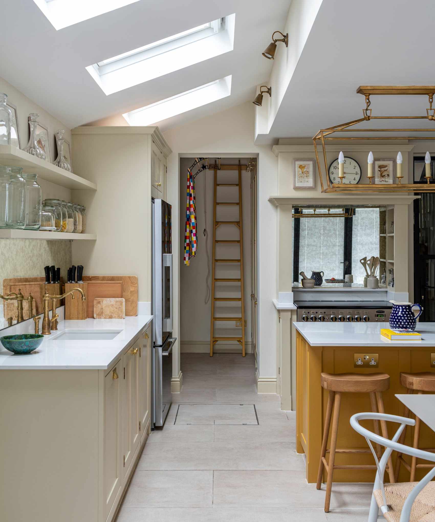 A kitchen with gray cabinets and wood fixtures
