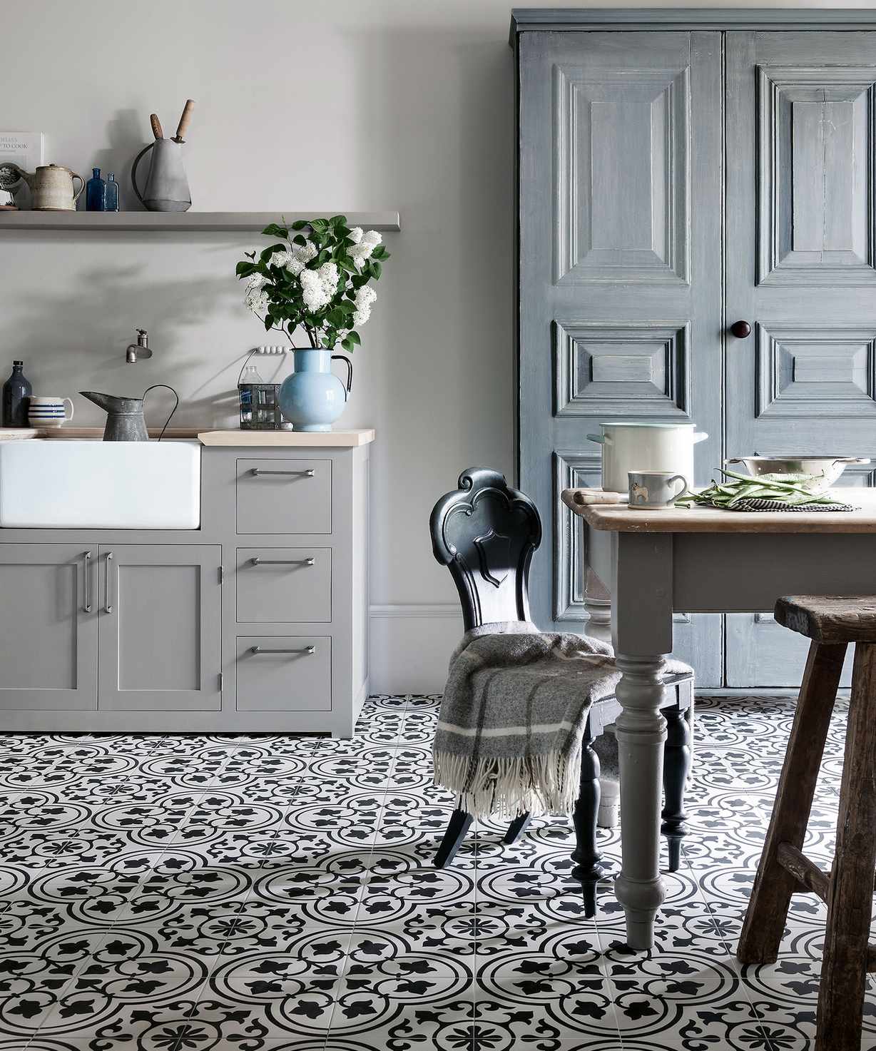 farmhouse kitchen with blue cabinets and patterned tile floor