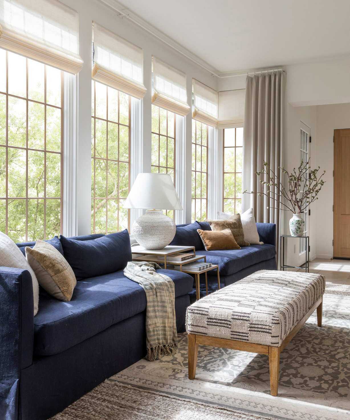 sunroom with large windows and a navy couch