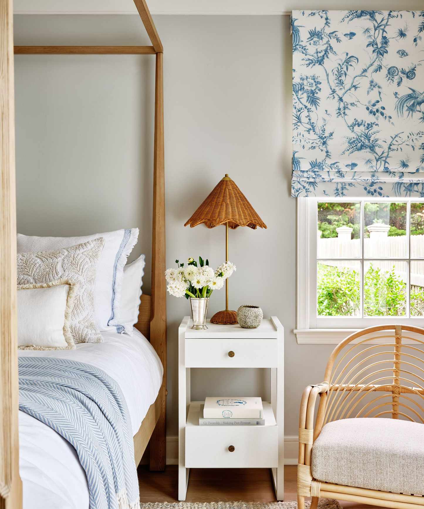 blue and white summer bedroom with natural furniture and woven accessories