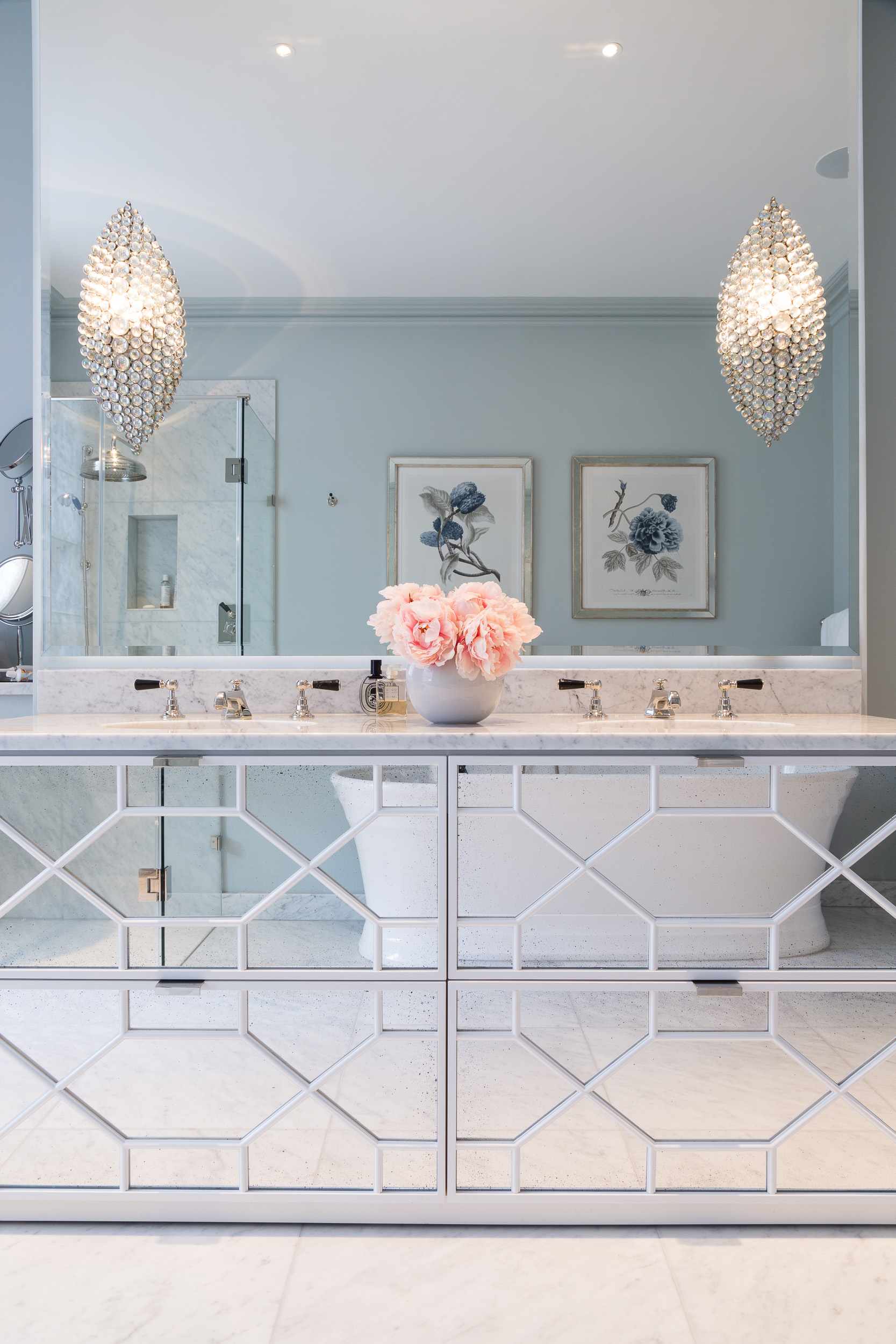 An example of how to make a small bathroom look bigger showing a bathroom with mirrored furniture