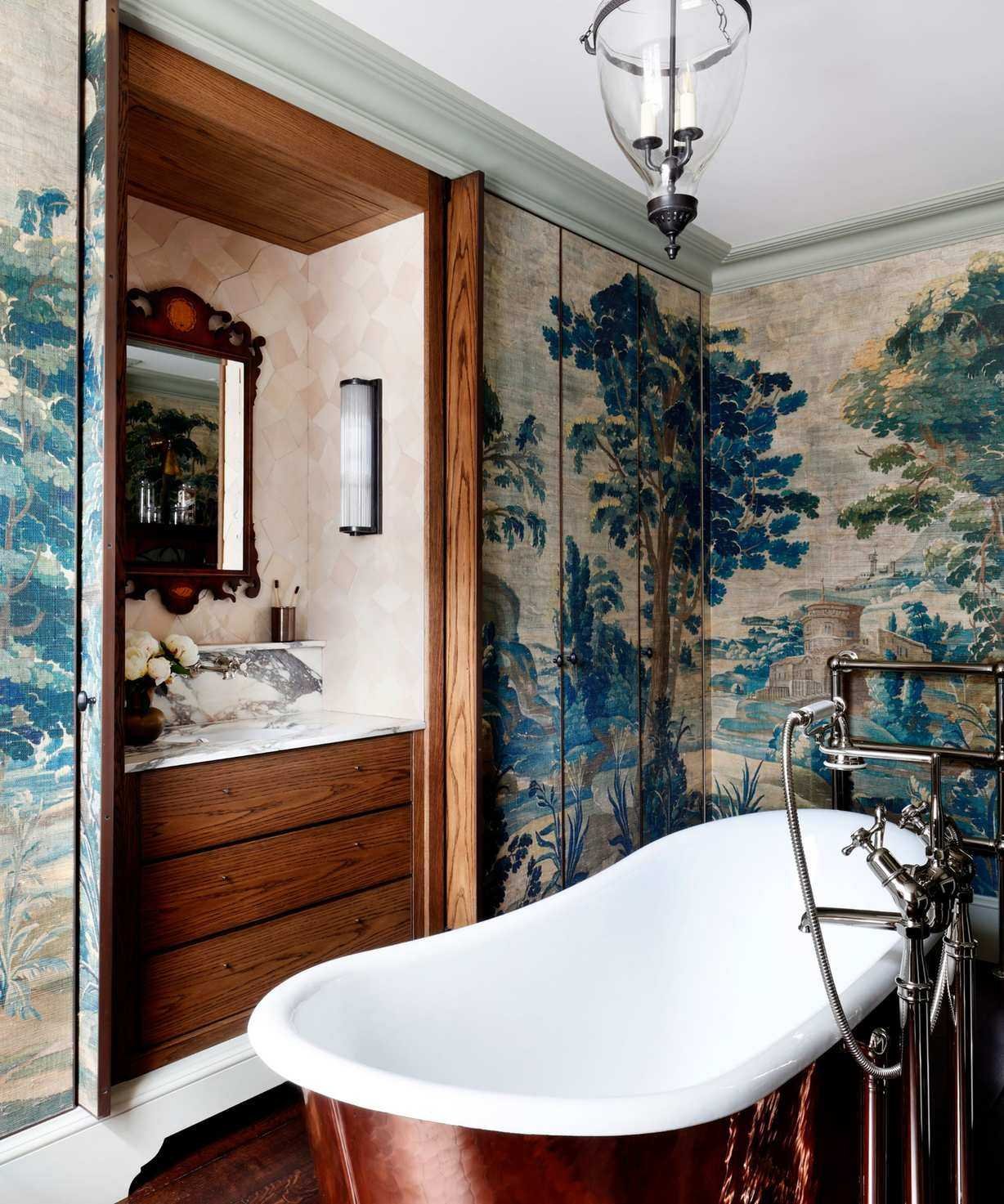 A broken plan bathroom with a freestanding bathtub and a vanity hidden behind pocket doors