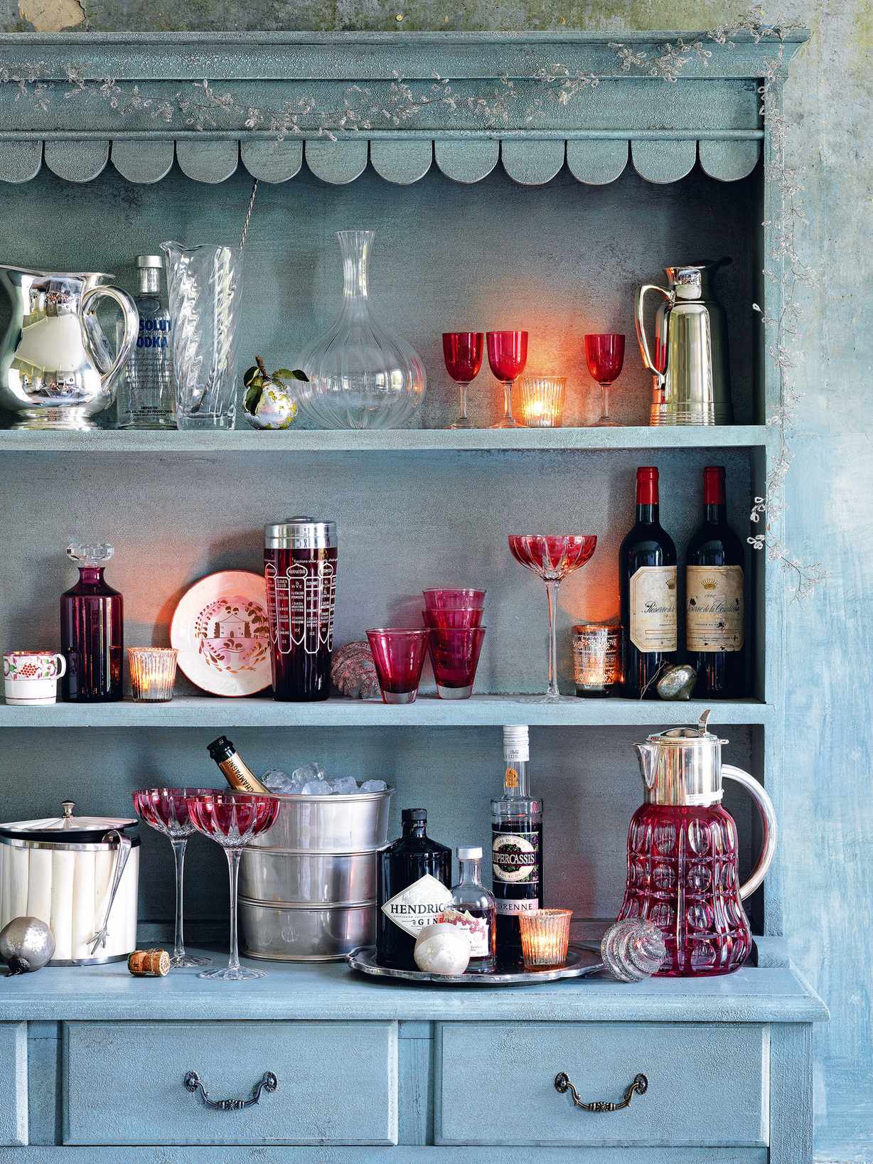 blue vintage kitchen dresser with red glasses and drinks