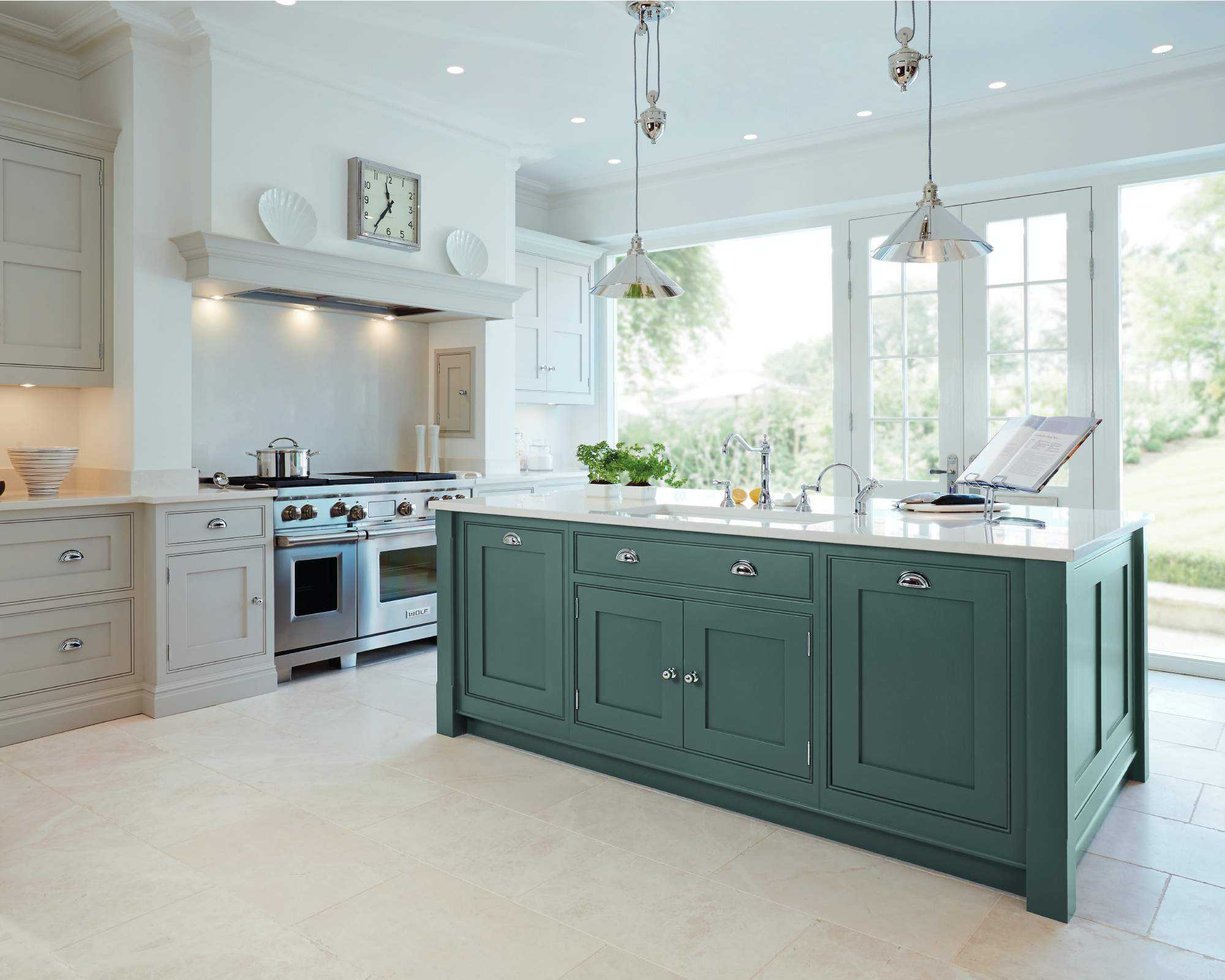 Open plan kitchen featuring a green kitchen island in white kitchen.